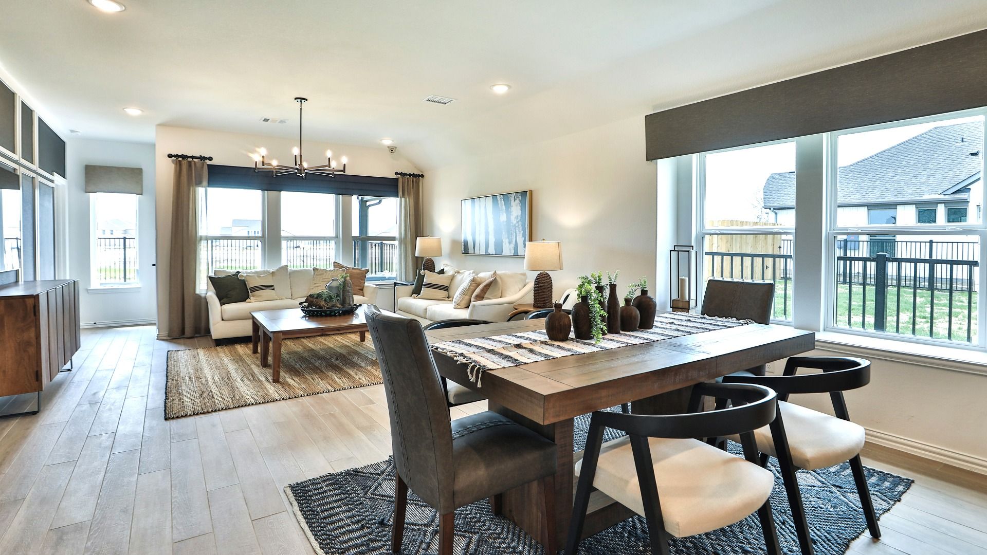 Luxurious open-concept space with expansive windows, sleek wood flooring, and elegant fixtures in Bridgeland, Cypress.