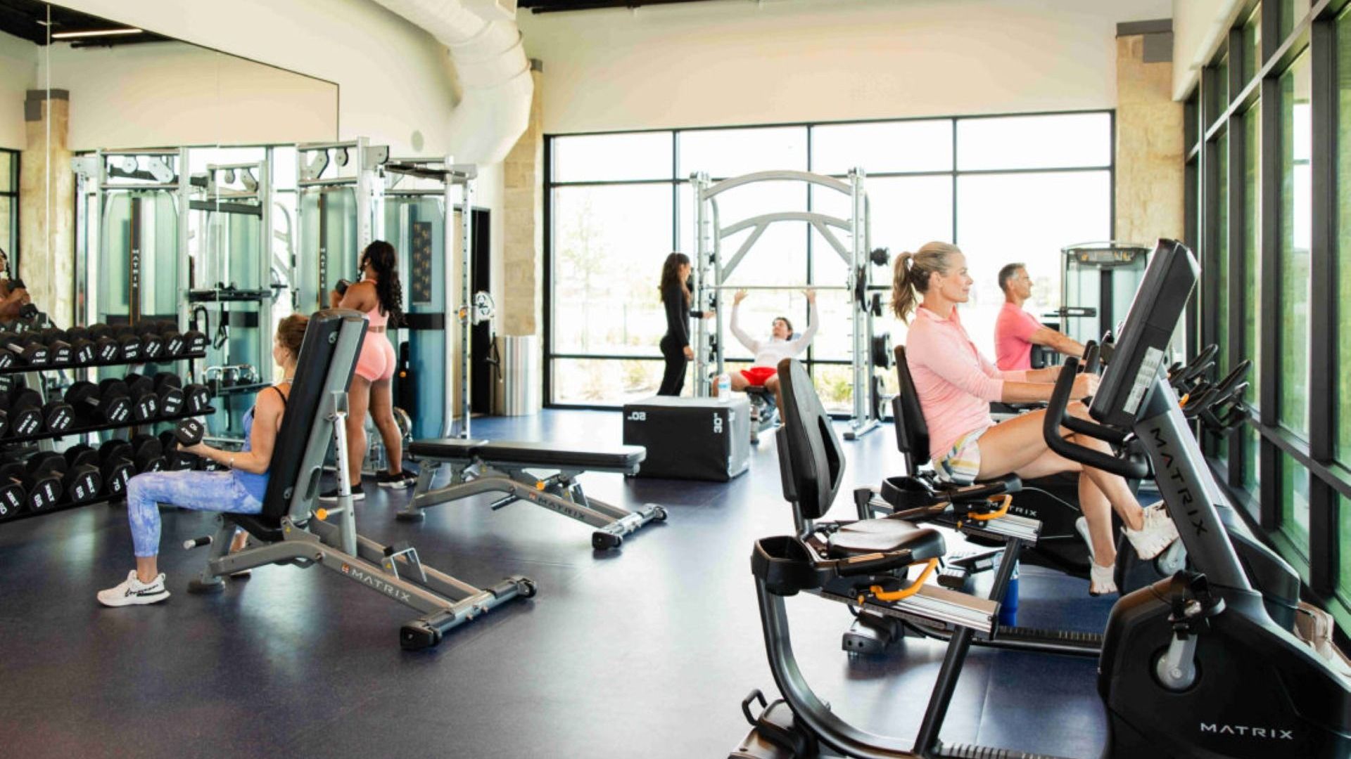 Sunterra gym features expansive windows and state-of-the-art fitness equipment. Perfect for luxury workouts.