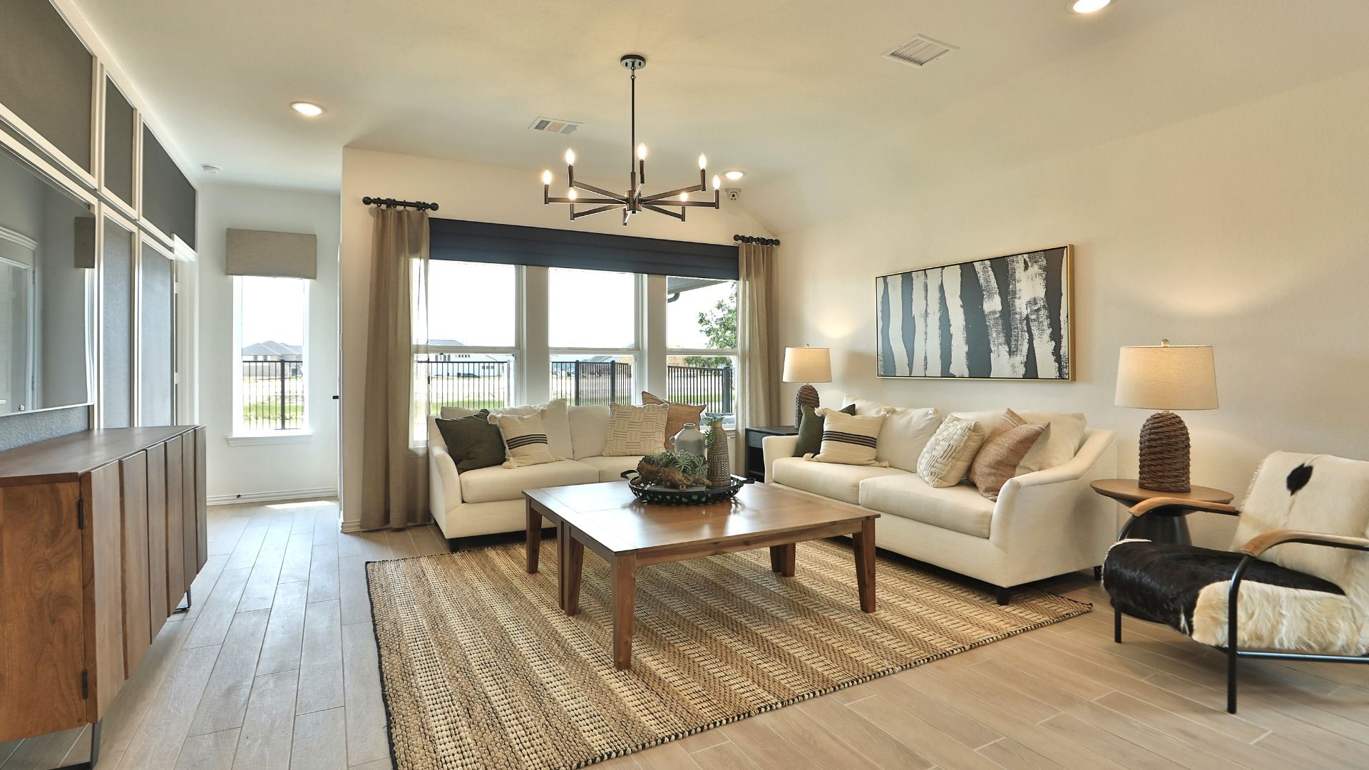 Exquisite wood flooring and chic furnishings adorn this Bridgeland living room.