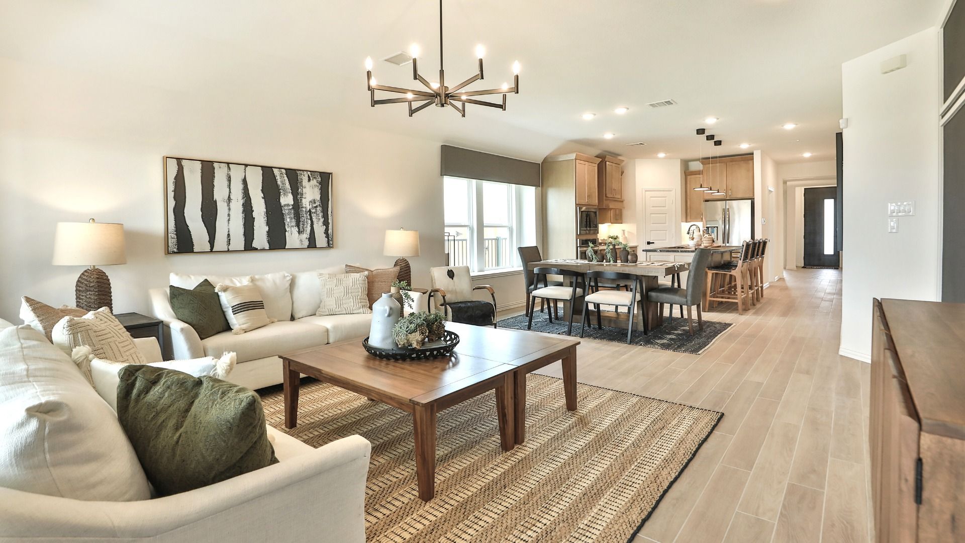 Bridgeland living room with a striking chandelier, sophisticated paneling, and elegant wood accents.