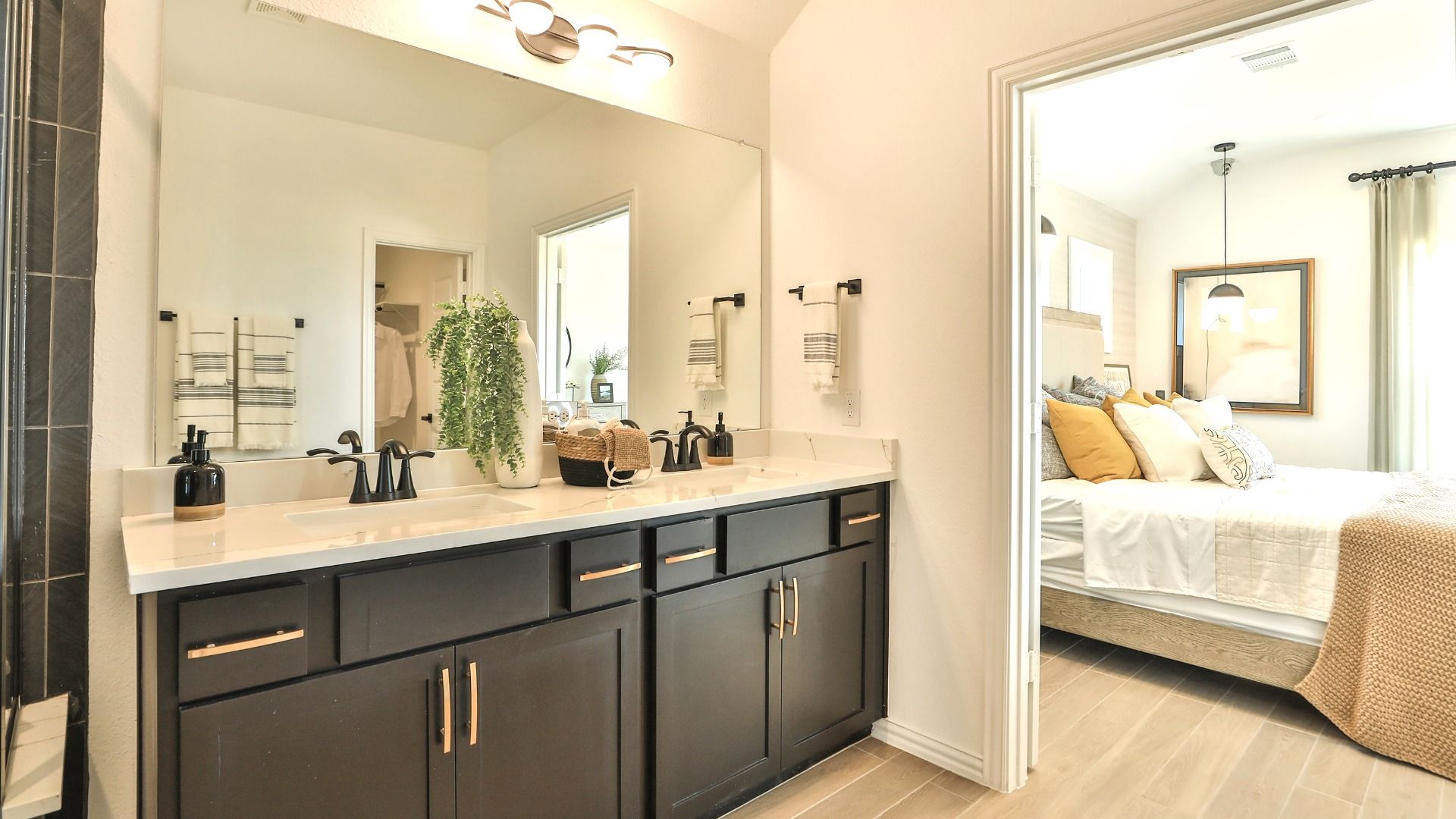 Experience sophistication with a sleek dark vanity and elegant fixtures in Bridgeland's refined residences.