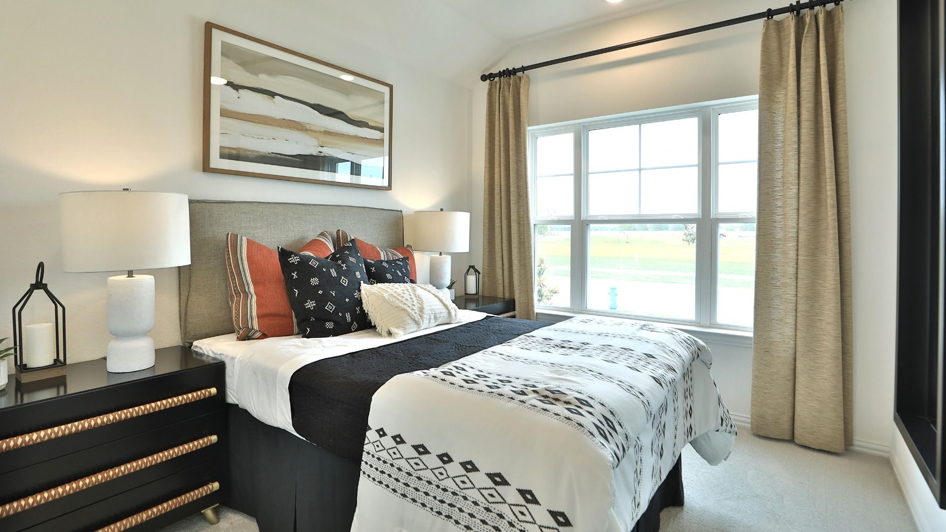 Luxurious bedroom features refined materials, expansive window, and exquisite decor in Bridgeland.