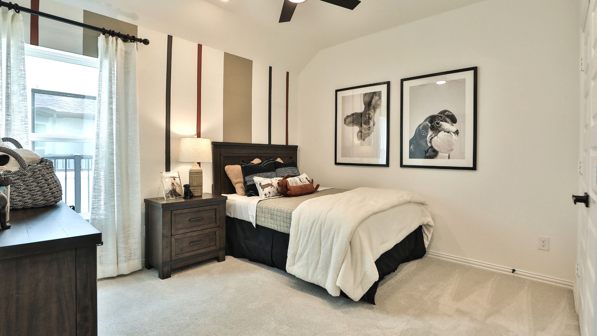 Luxuriously designed bedroom with rich wooden accents and chic artwork in Bridgeland, Texas.