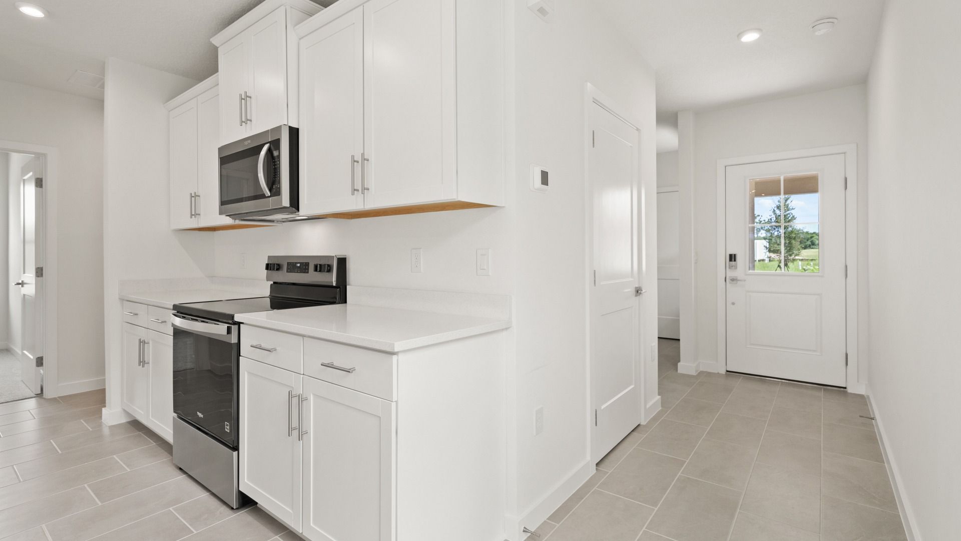 View of the interior entry and the kitchen in the Flagler by DRB Homes in Hamilton Bluff