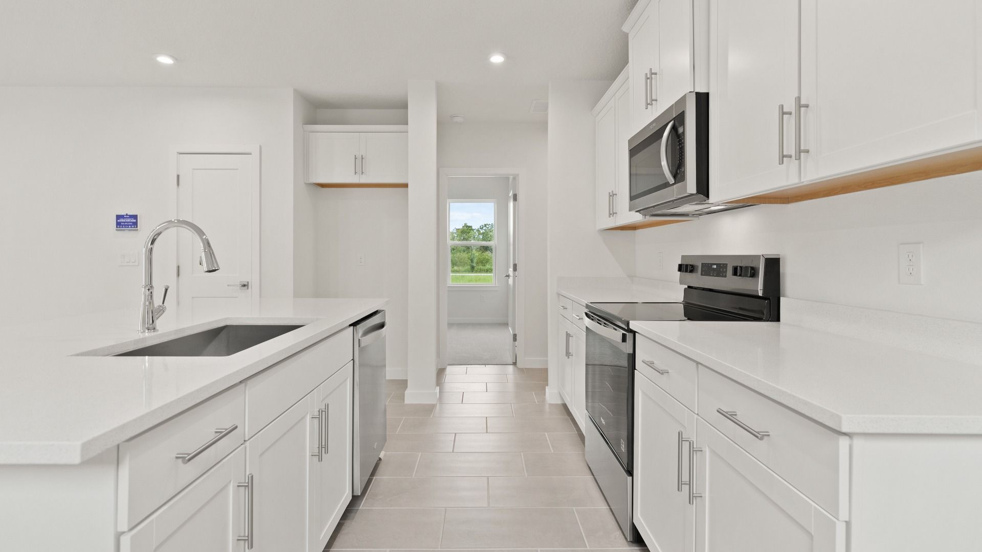 Bright Kitchen featuring a large kitchen island in the Flagler by DRB Homes in Hamilton Bluff.