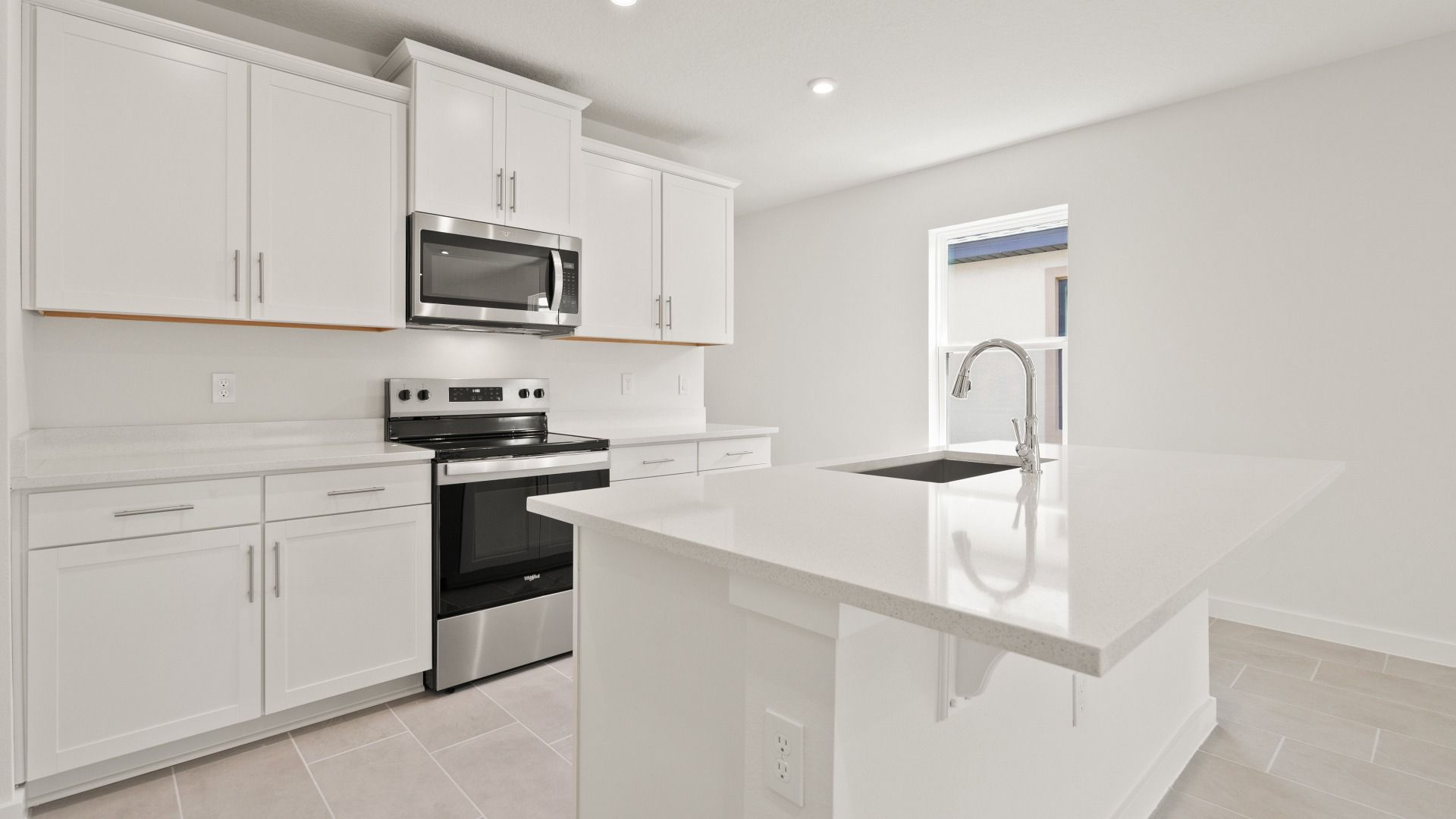 Bright Kitchen and Island in the Flager by DRB Homes in Hamilton Bluff.