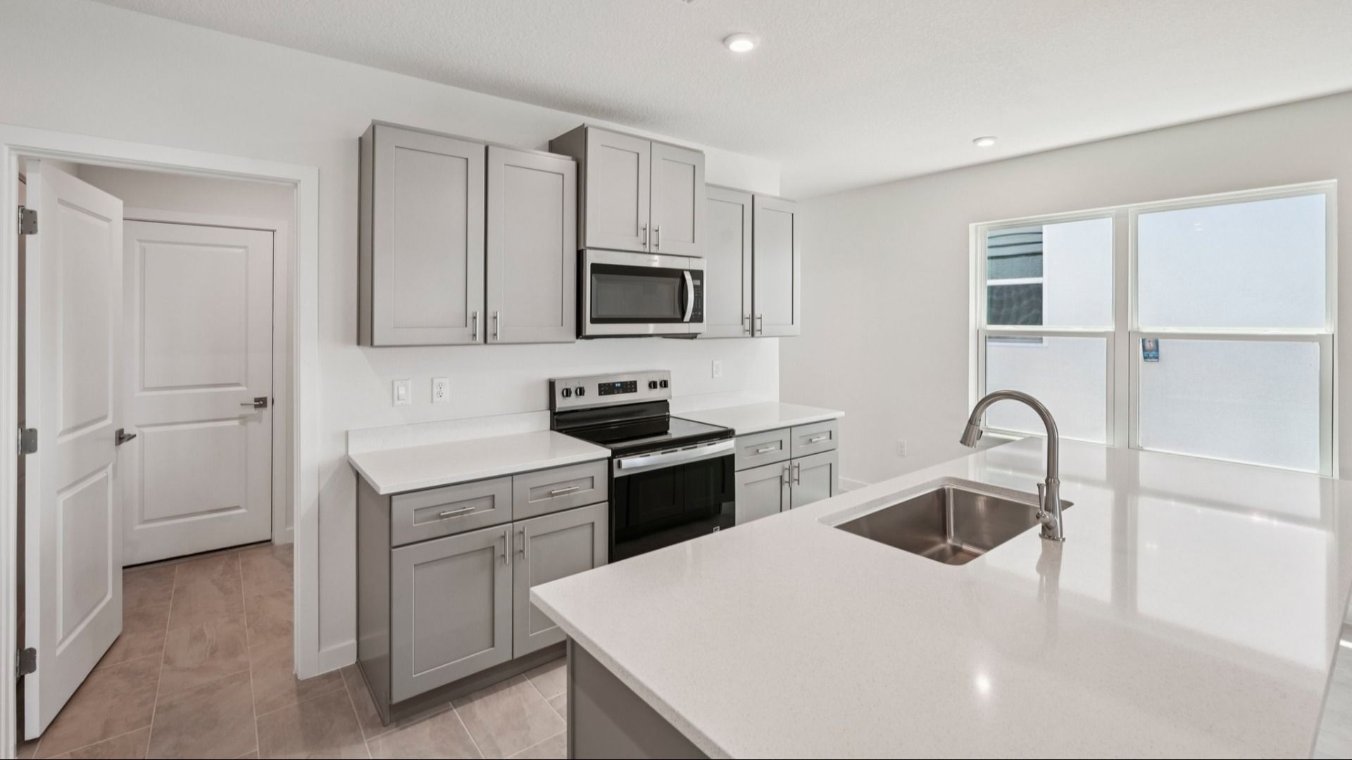 Kitchen and Island of the Jupiter in Hamilton Bluff located in Haines City, FL.