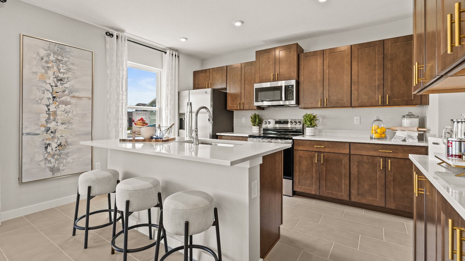 The Kitchen and Island in Model Highbourne by DRB Homes in Hamilton Bluff located in Haines City, FL.