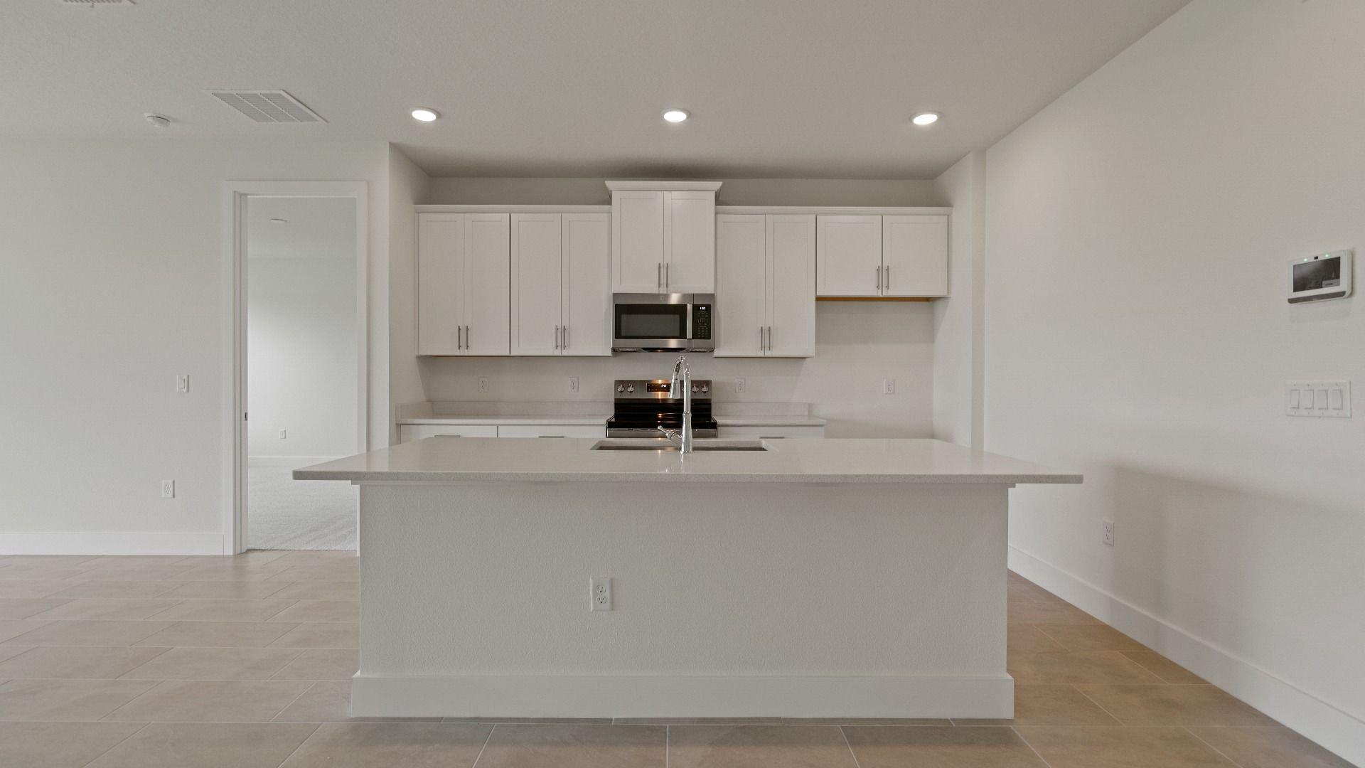 Kitchen and Large Island of the Buttonwood by DRB Homes at Trailside in Mount Dora, FL.