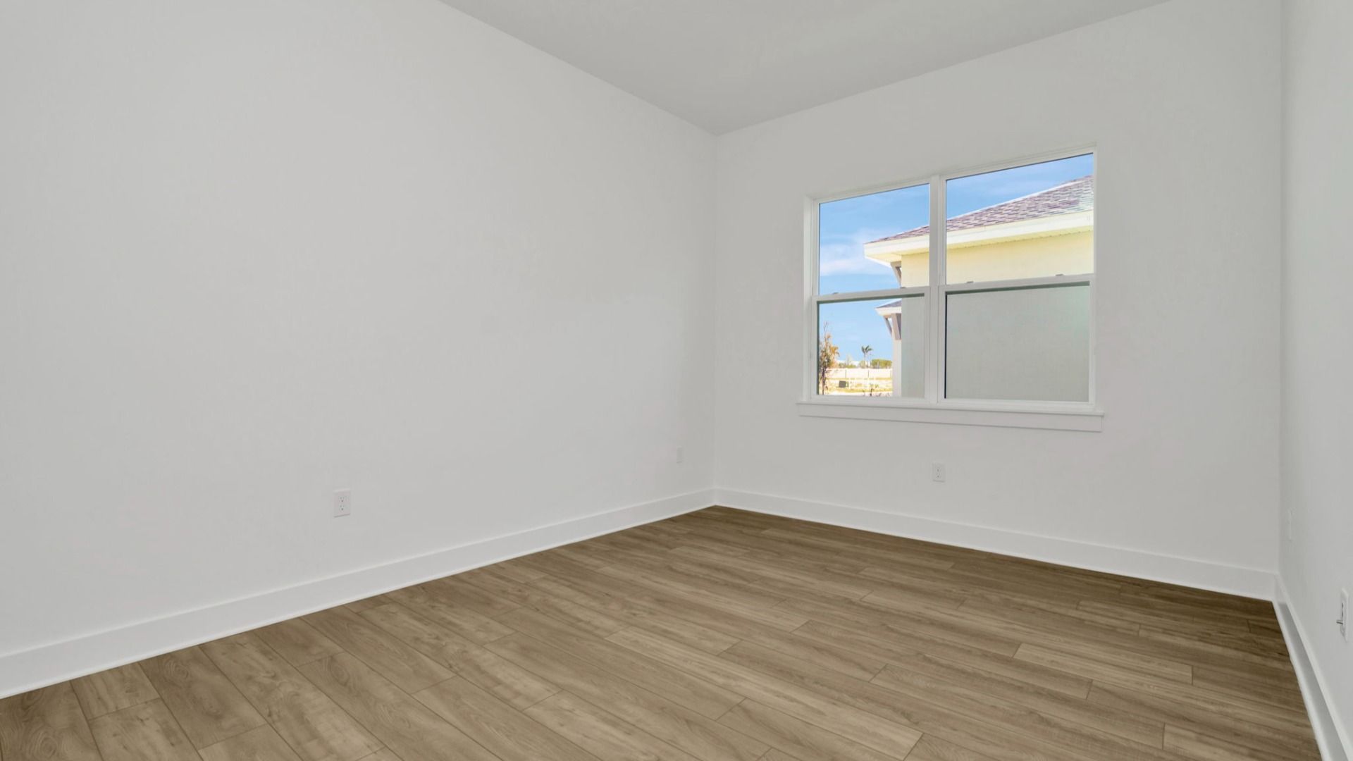 The Second Bedroom of a DRB Homes Grand Hawk which is offered as a home plan at Serengeti in Spring Hill, FL.