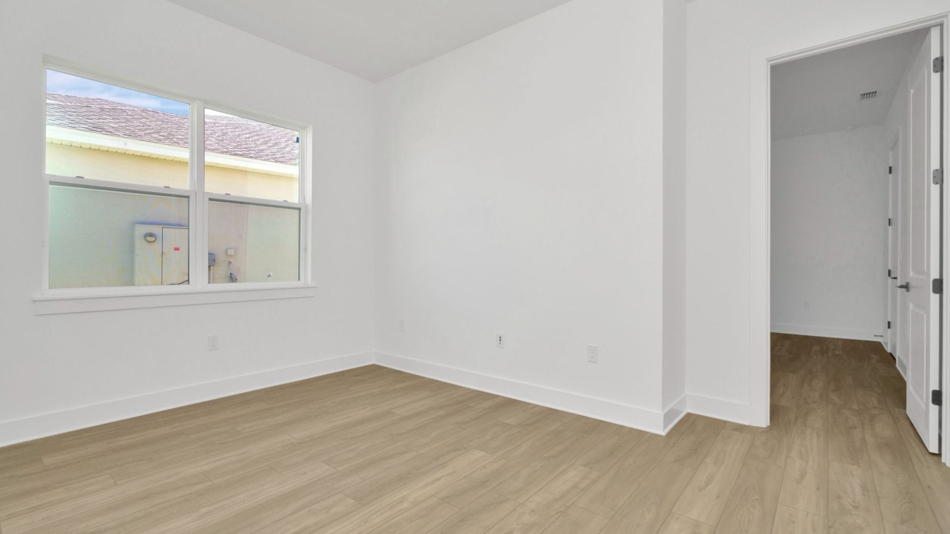The Second Bedroom of a DRB Homes Grand Hawk which is offered as a home plan at Serengeti in Spring Hill, FL.