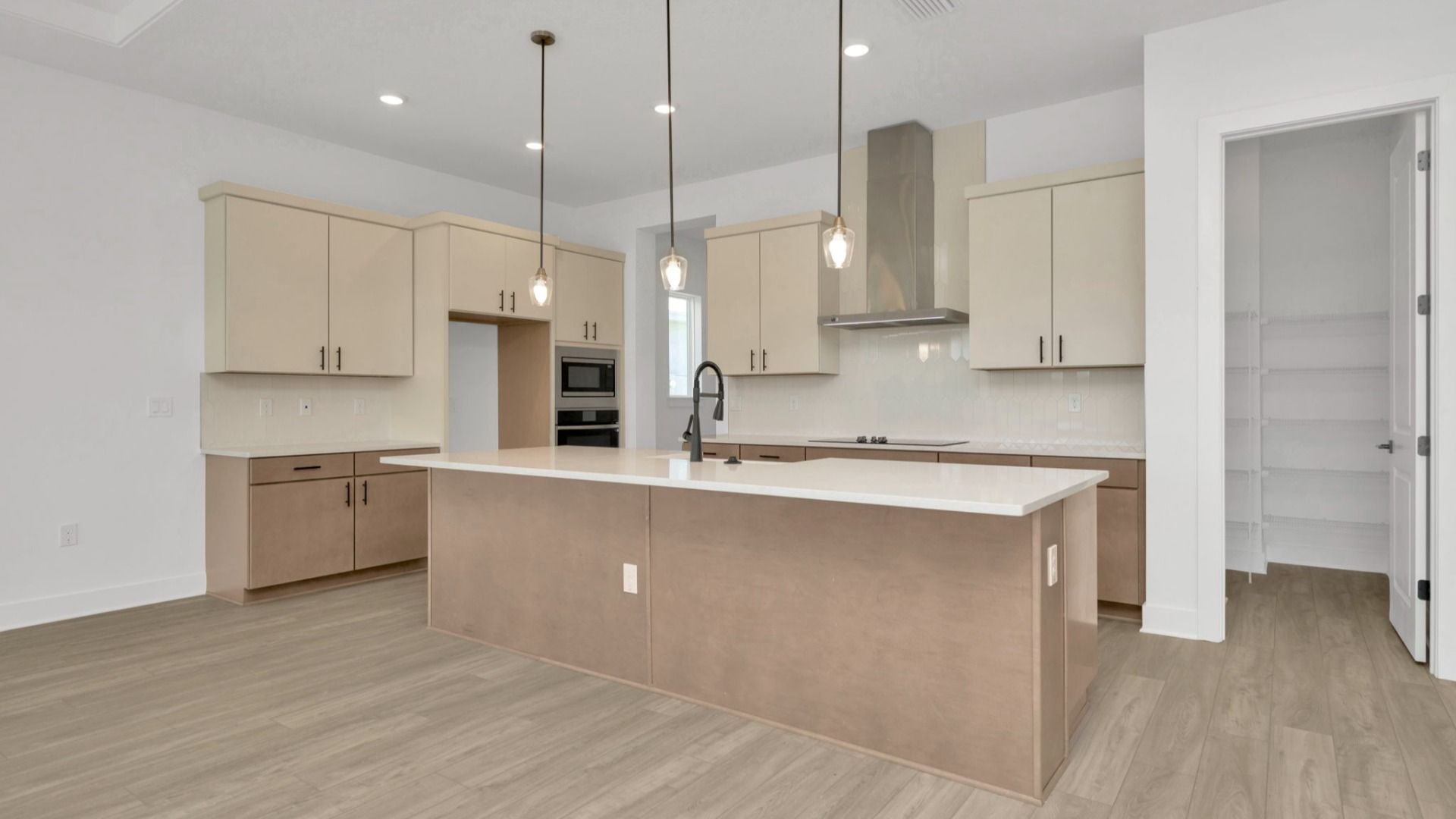 The Kitchen of a DRB Homes Grand Hawk which is offered as a home plan at Serengeti in Spring Hill, FL.