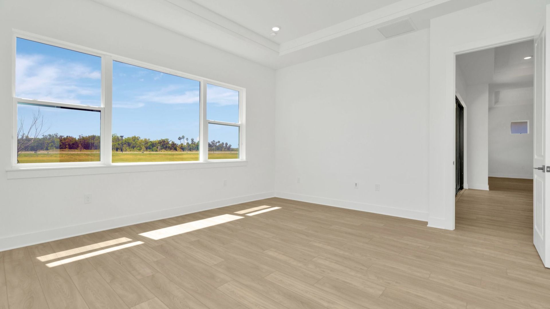 The Primary Bedroom of a DRB Homes Grand Hawk which is offered as a home plan at Serengeti in Spring Hill, FL.