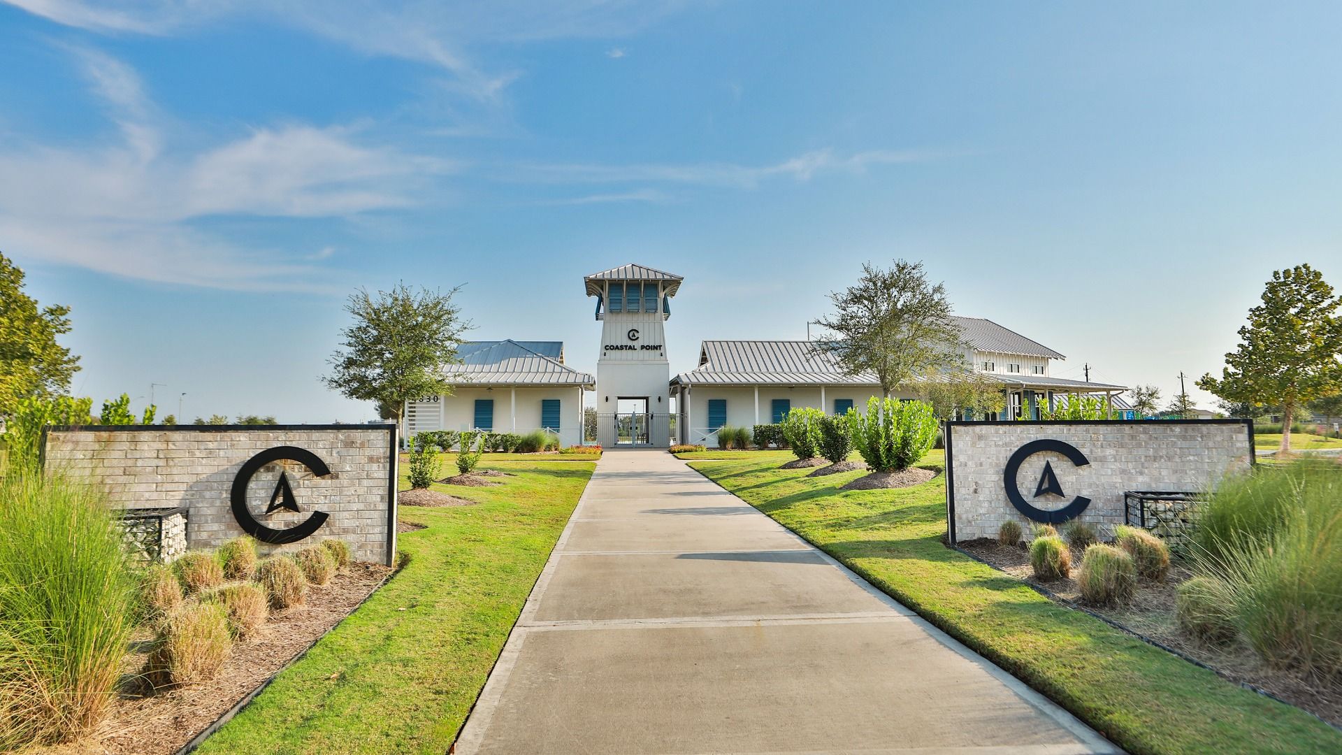Elegant clubhouse with sleek metal roofing and manicured gardens in League City, Texas.