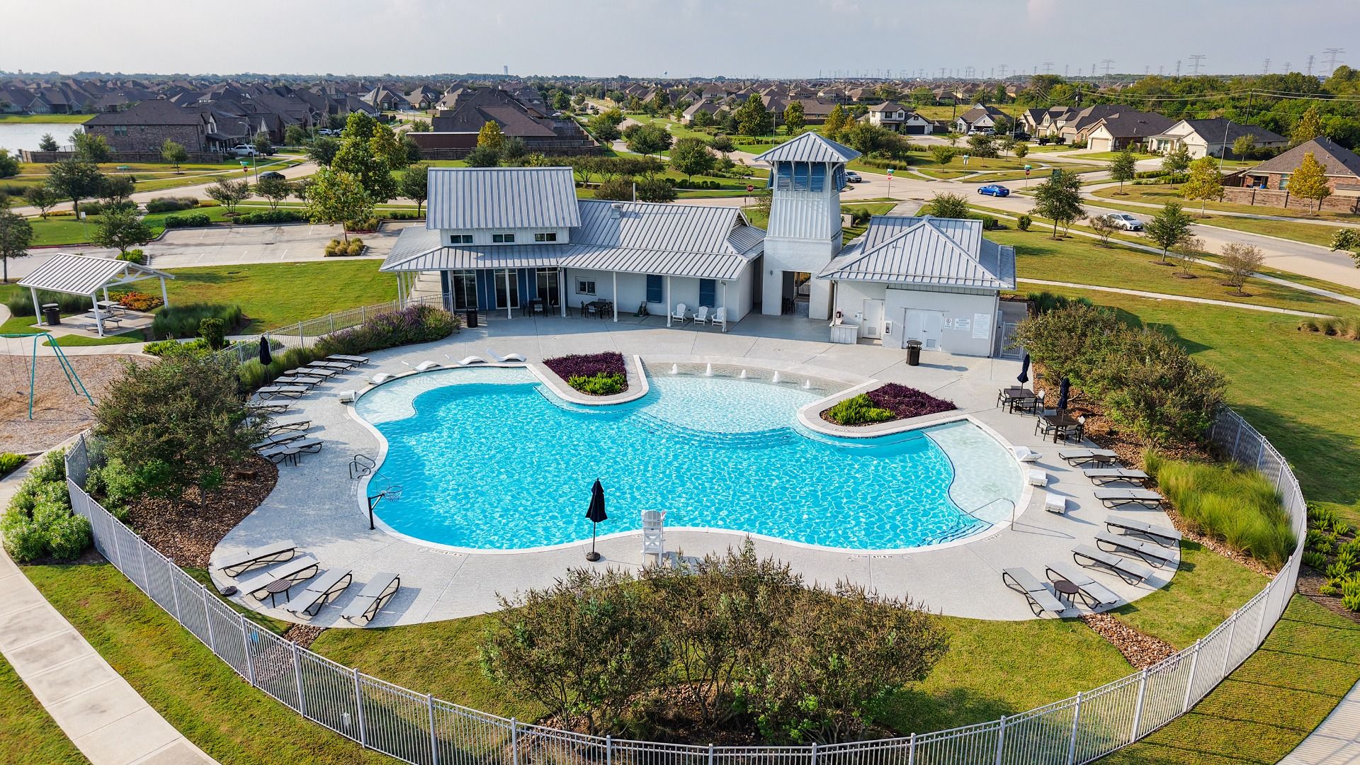 Elegant resort-style pool with sleek clubhouse, offering a luxurious retreat in League City, TX.