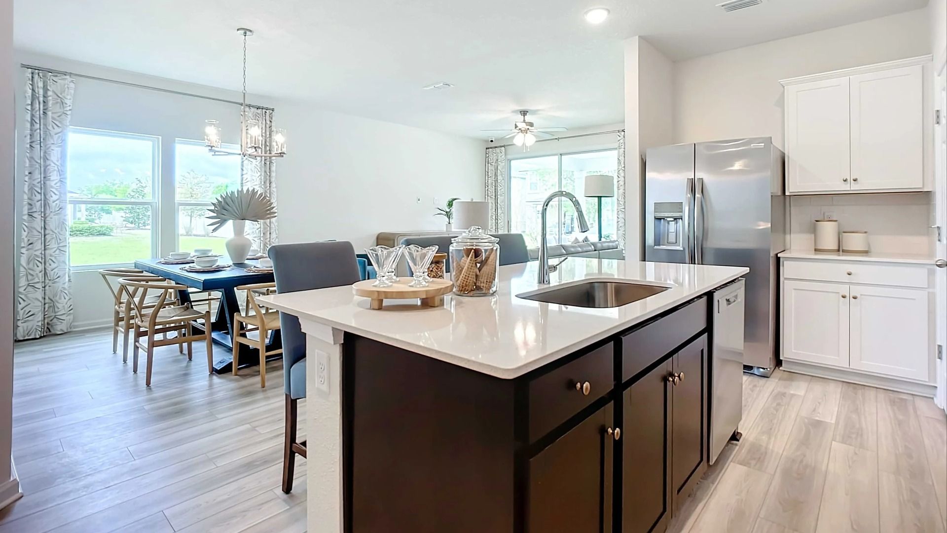 Luxurious kitchen with quartz island, stainless appliances, and designer lighting in Panther Creek.