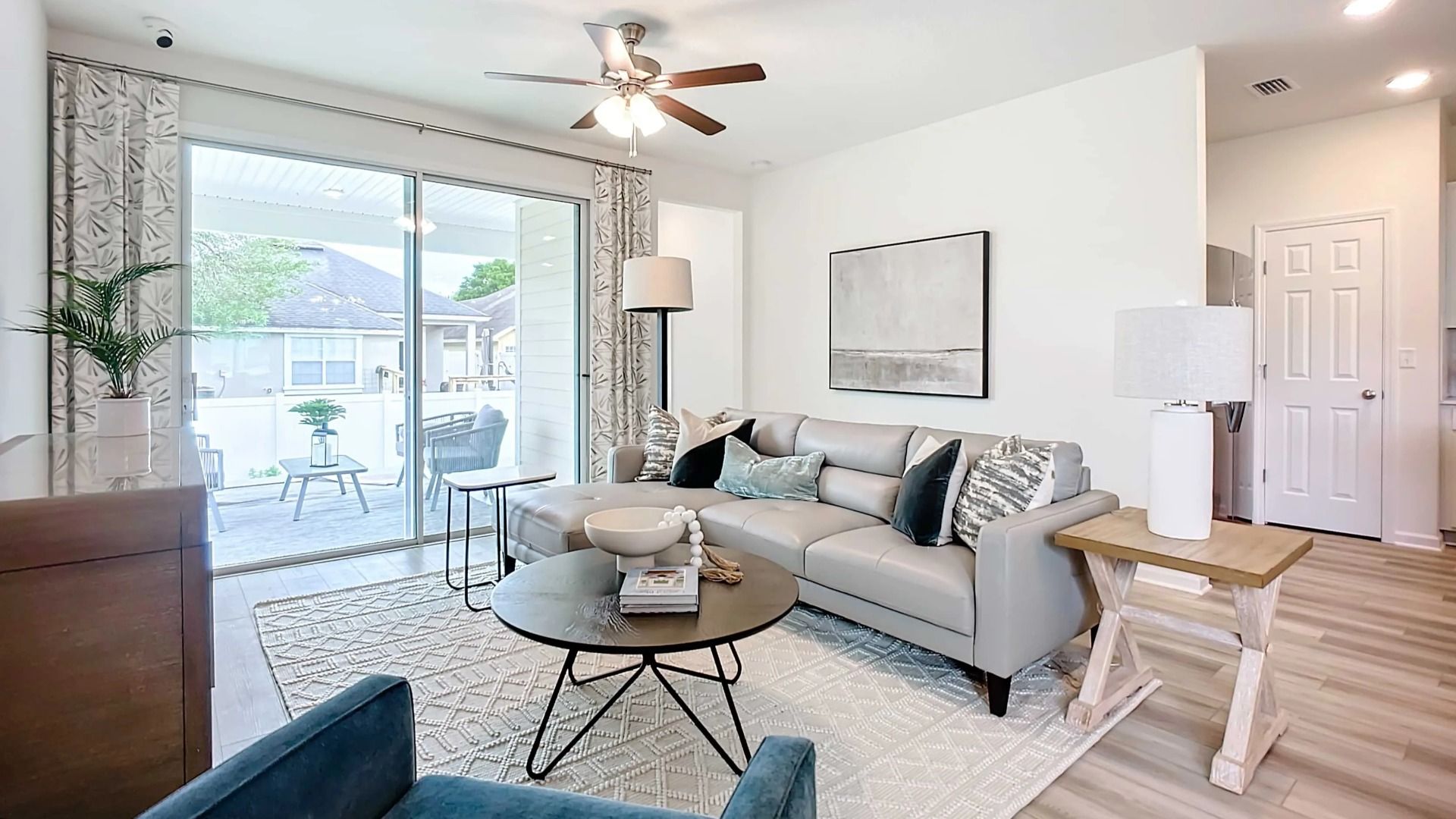 Discover refined elegance with sleek furnishings and abundant natural light in Panther Creek's luxurious living area.