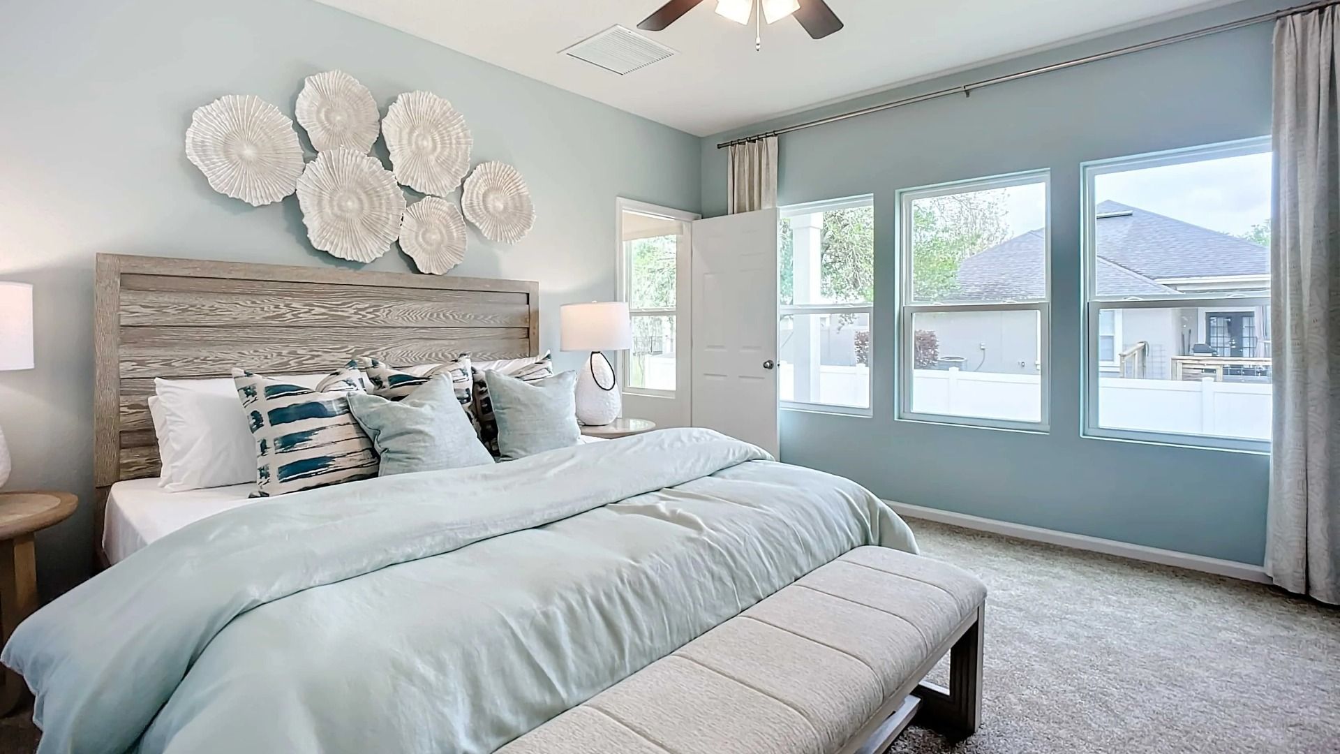 Discover serenity in this Panther Creek bedroom with expansive windows and artistic textures.