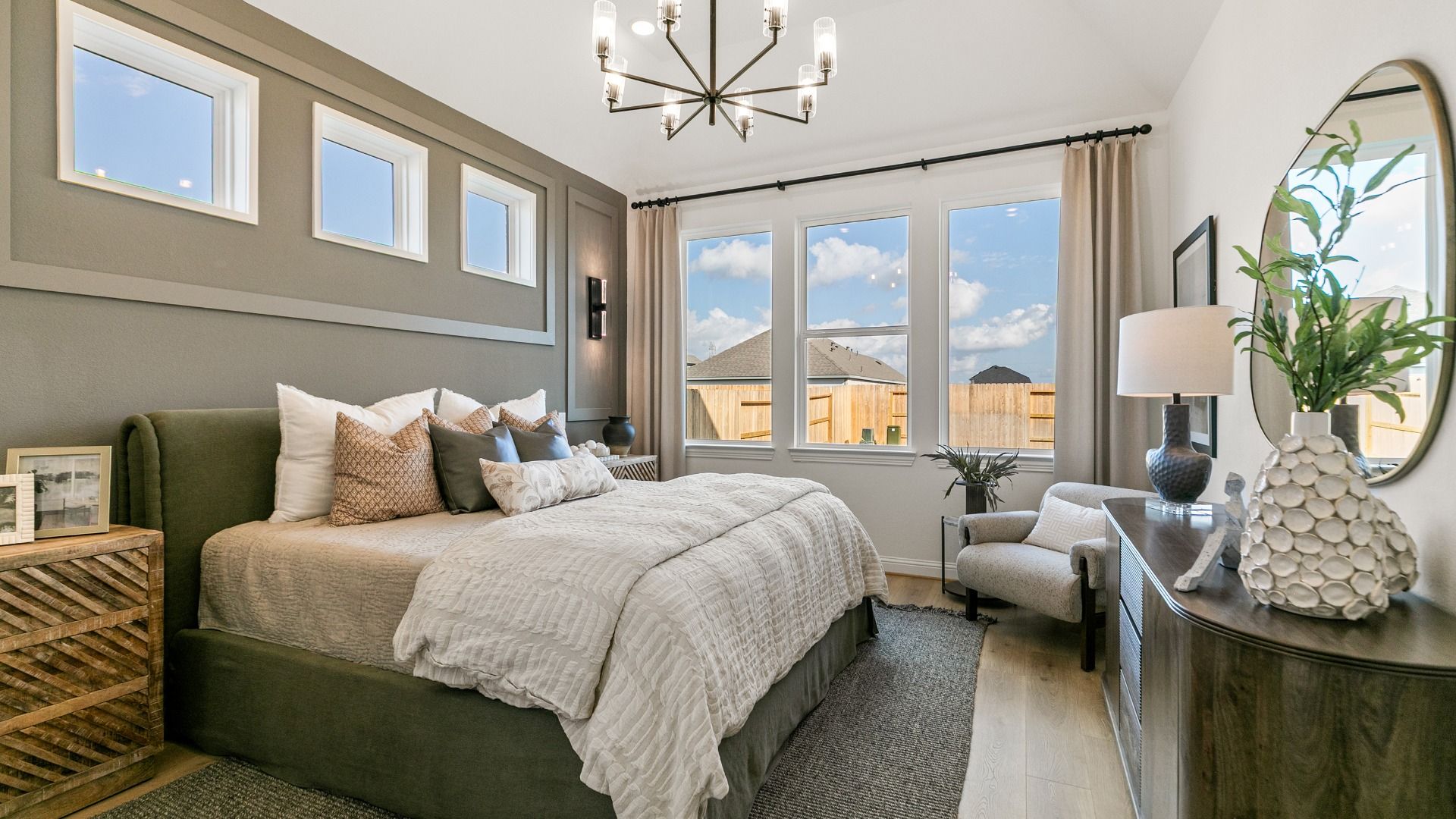 Sunlit windows and contemporary fixtures create a polished primary suite.