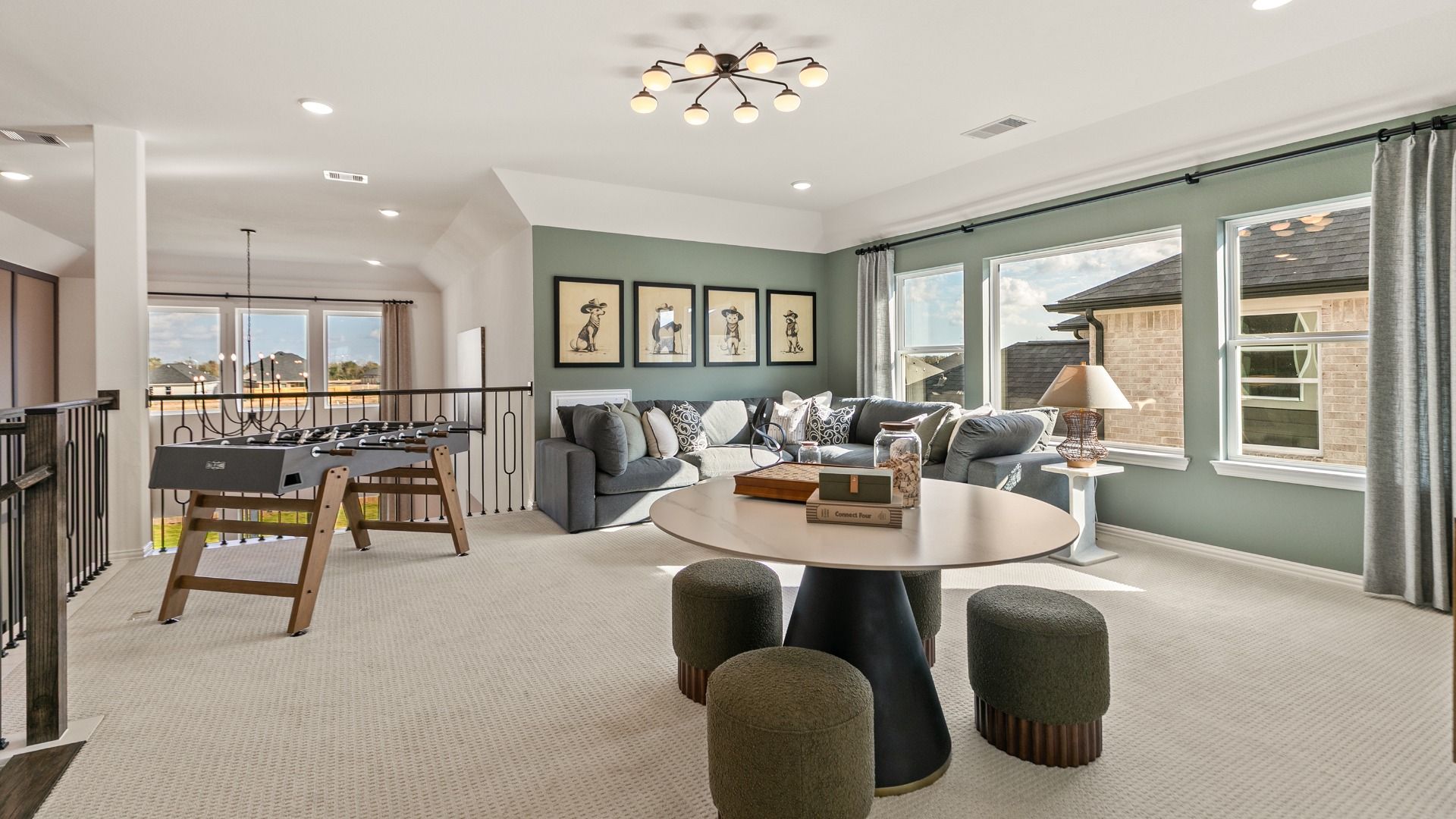 Upstairs game room overlooking the main living space below in Creekhaven by DRB Homes.