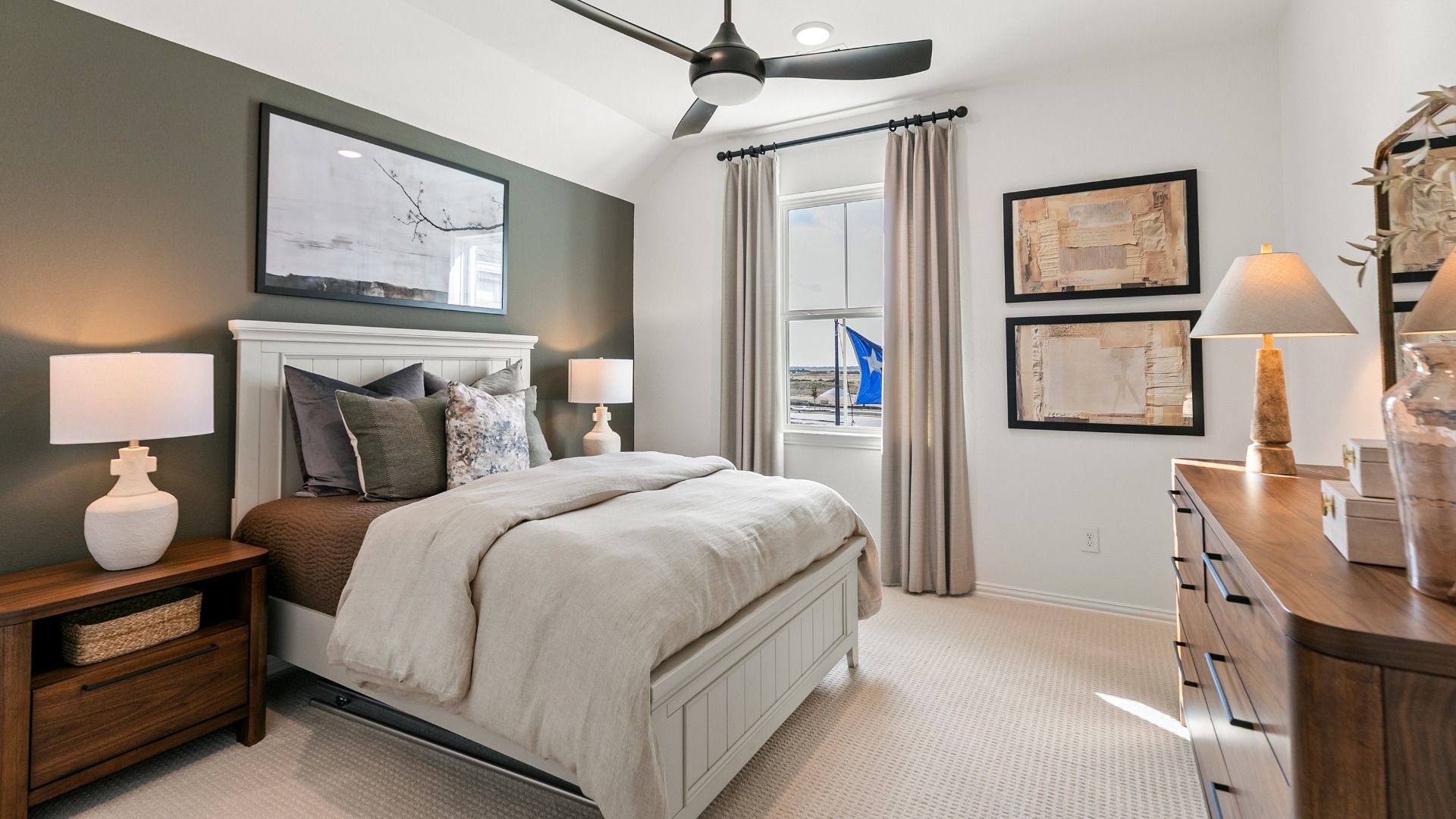 Junior suite with sage green accent wall and an attached bath.