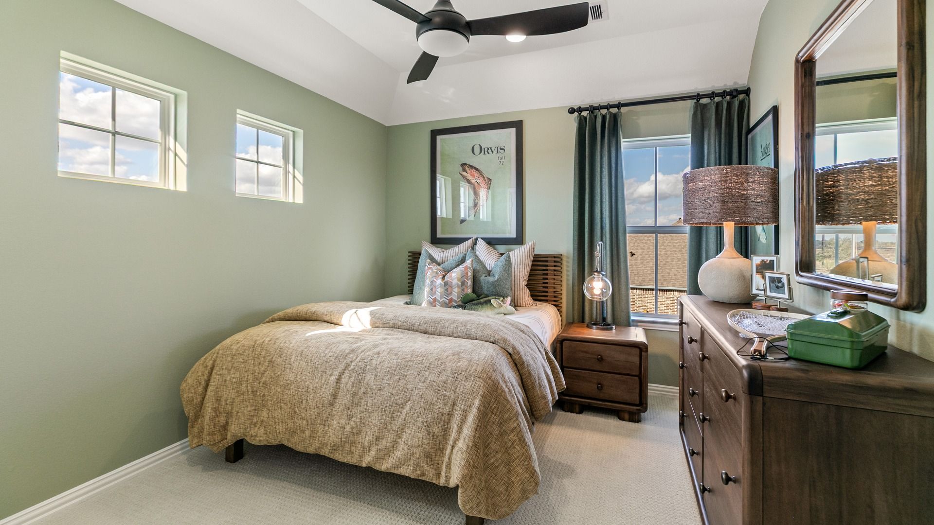 Secondary bedroom with light green walls and windows allowing for natural light.