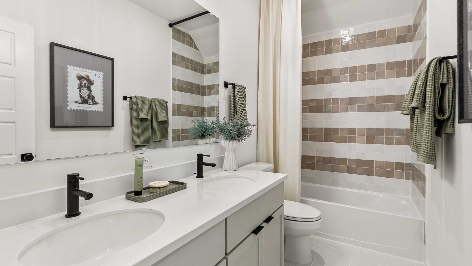 Additional upstairs bathroom with unique tile design and bright white countertops in Creekhaven.