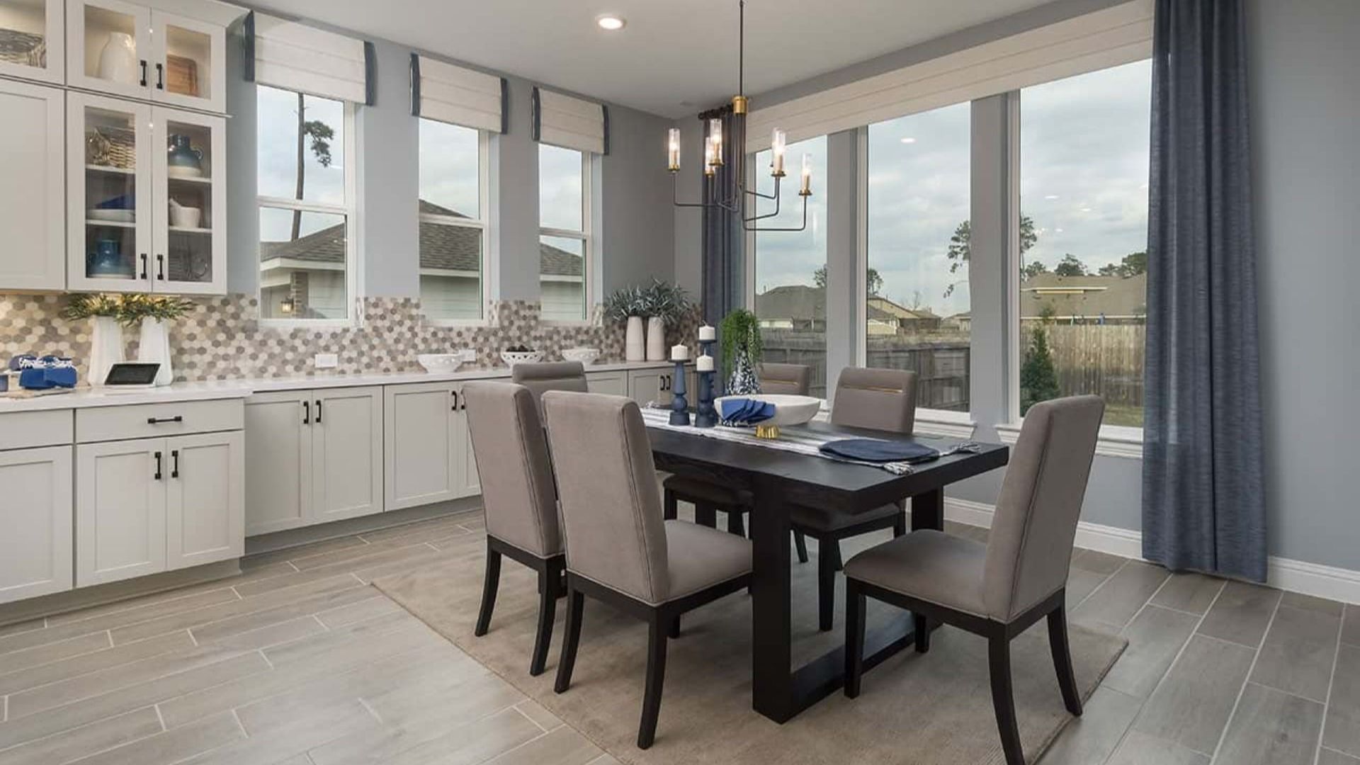 Revel in the luxury of expansive windows and chic chandeliers in Mostyn Manor Reserve's elegant dining room.