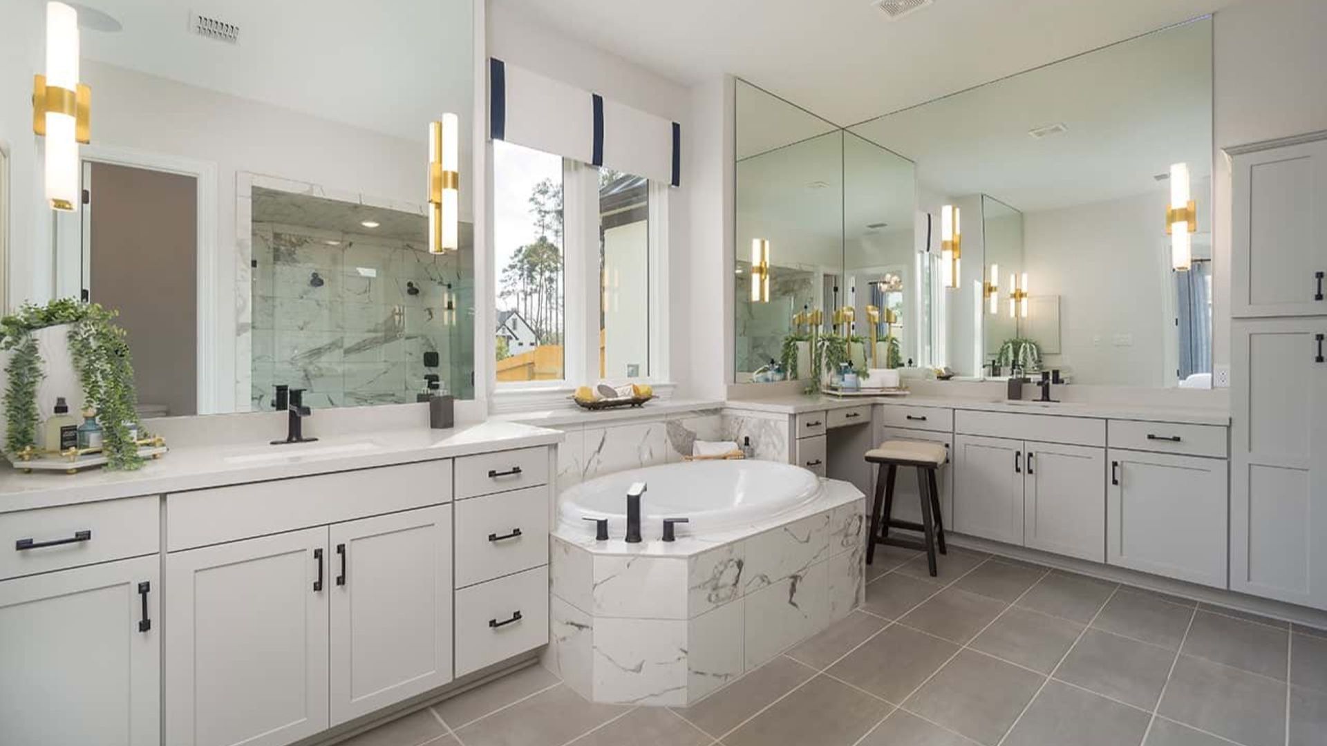 Indulge in marble elegance with a grand soaking tub, designer lighting, and ample natural light in Mostyn Manor Reserve.