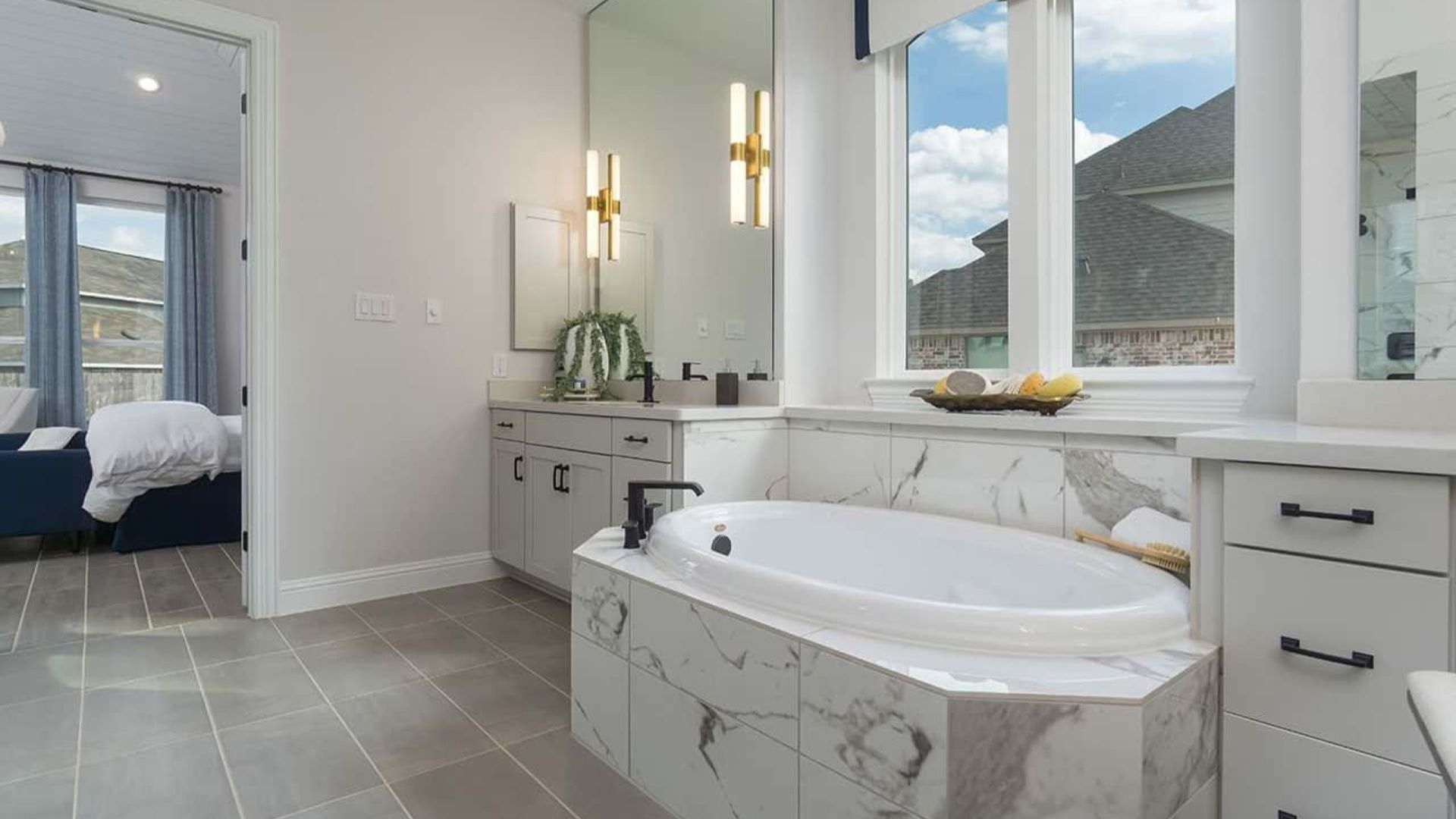 Indulge in this lavish Mostyn Manor Reserve bathroom, featuring a marble tub, dual vanities, and sleek modern fixtures.