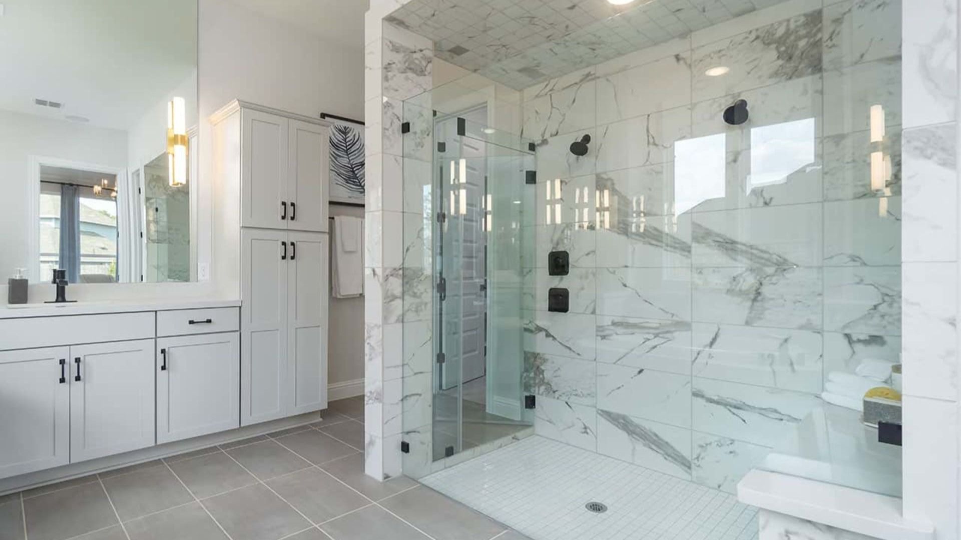 Experience elegance with floor-to-ceiling marble tiles and frameless glass shower in Mostyn Manor Reserve.