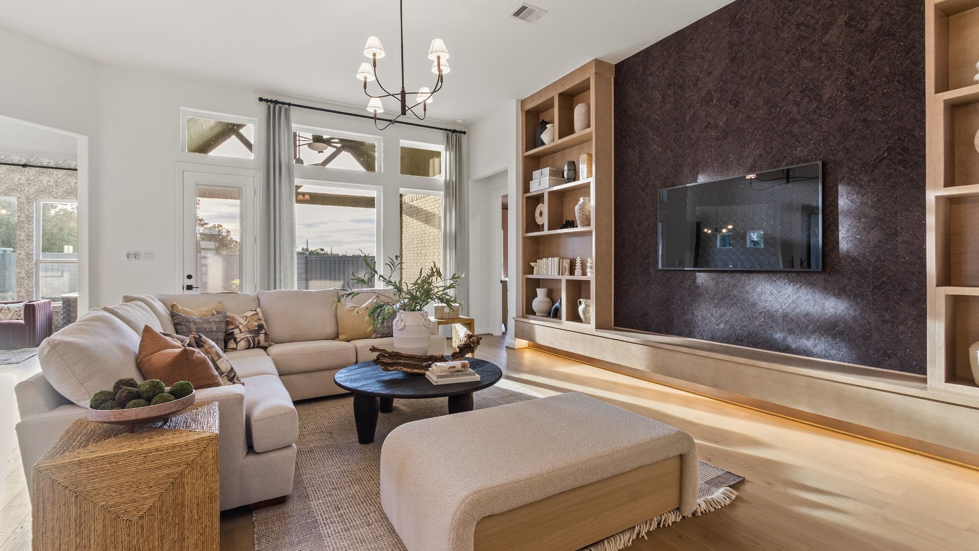 Luxurious finishes and custom built-in cabinetry bring elegance and functionality to this stunning great room by DRB Homes.