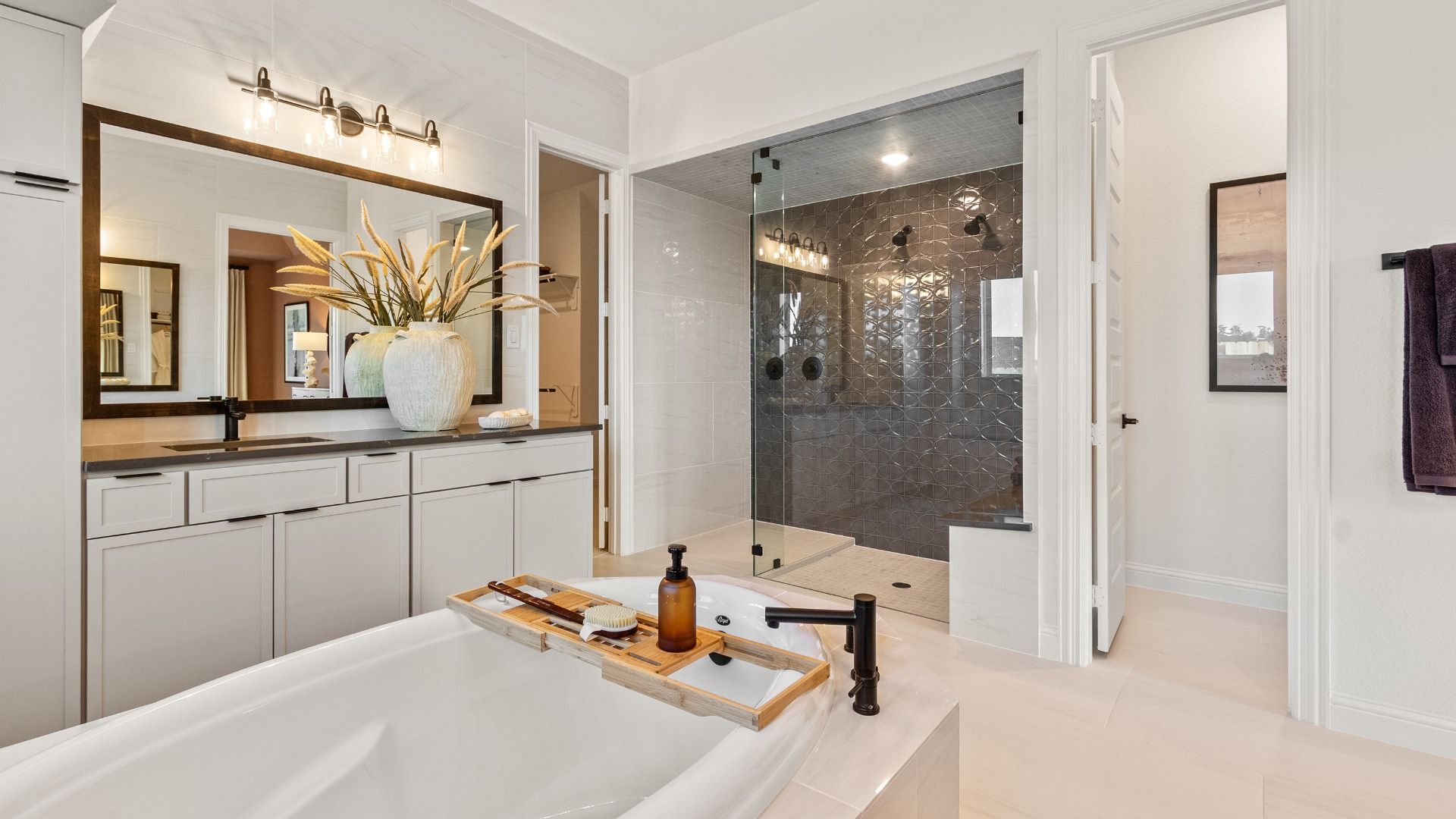 A large walk-in shower serves as the centerpiece of the beautifully designed primary bath in Sundance Cove.