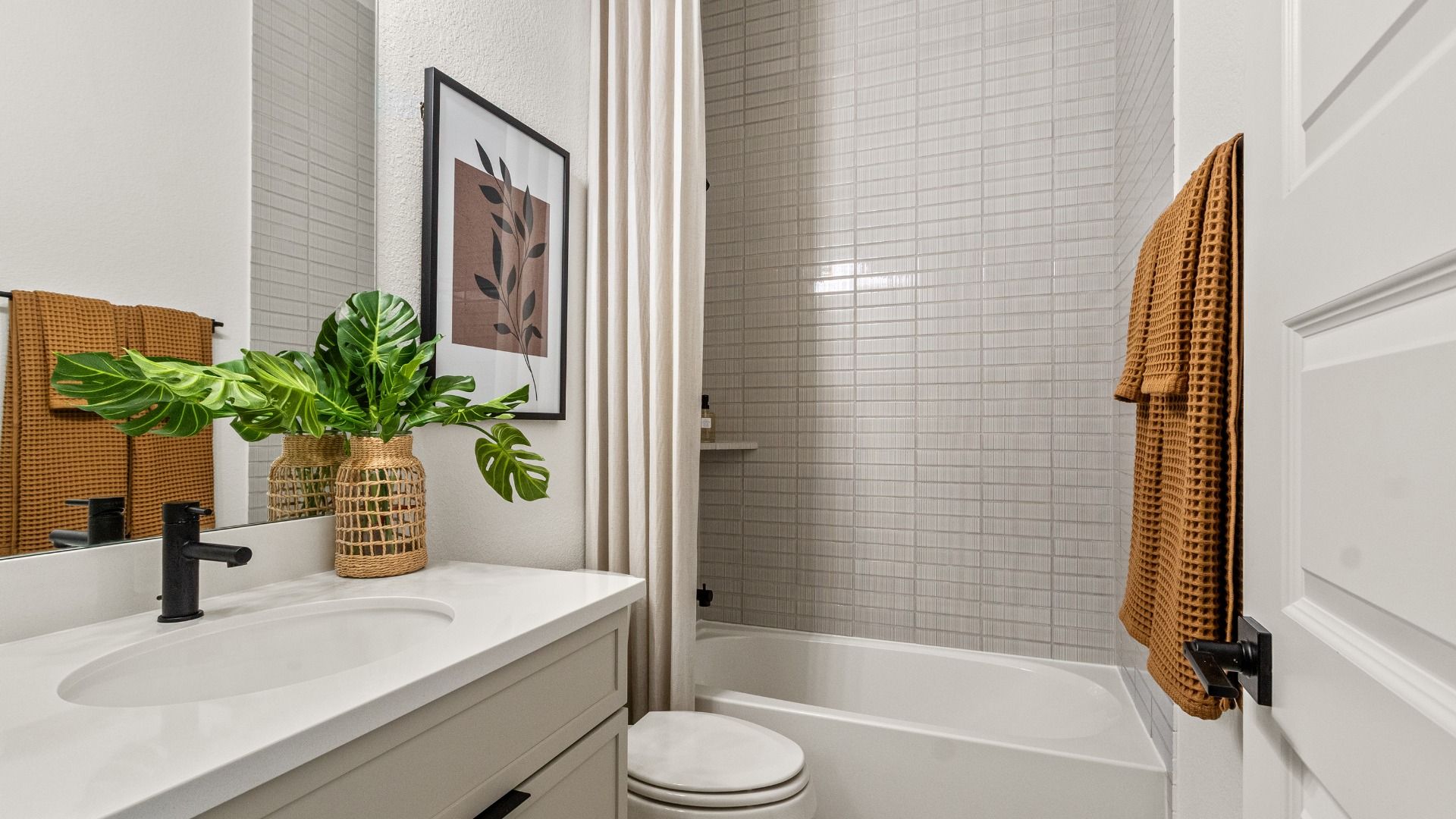 Sleek secondary bath with neutral color palette in Sundance Cove.