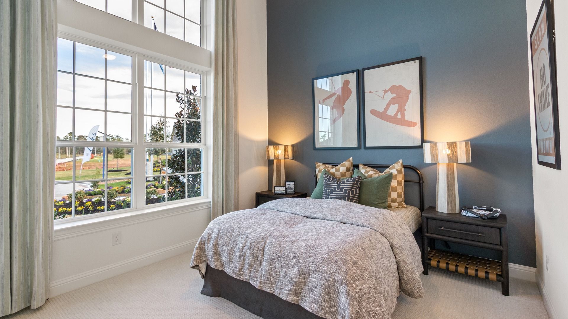 Secondary bedroom with soaring ceilings and expansive windows in Sundance Cove.