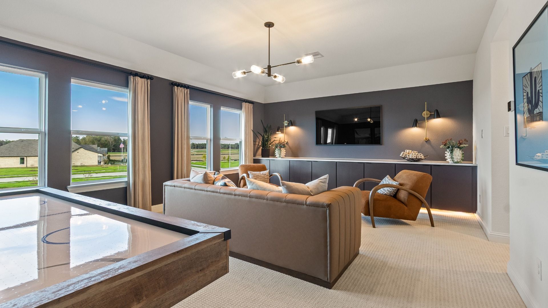 This versatile upstairs game room offers a light-filled retreat perfect for entertainment or casual living in Sundance Cove.
