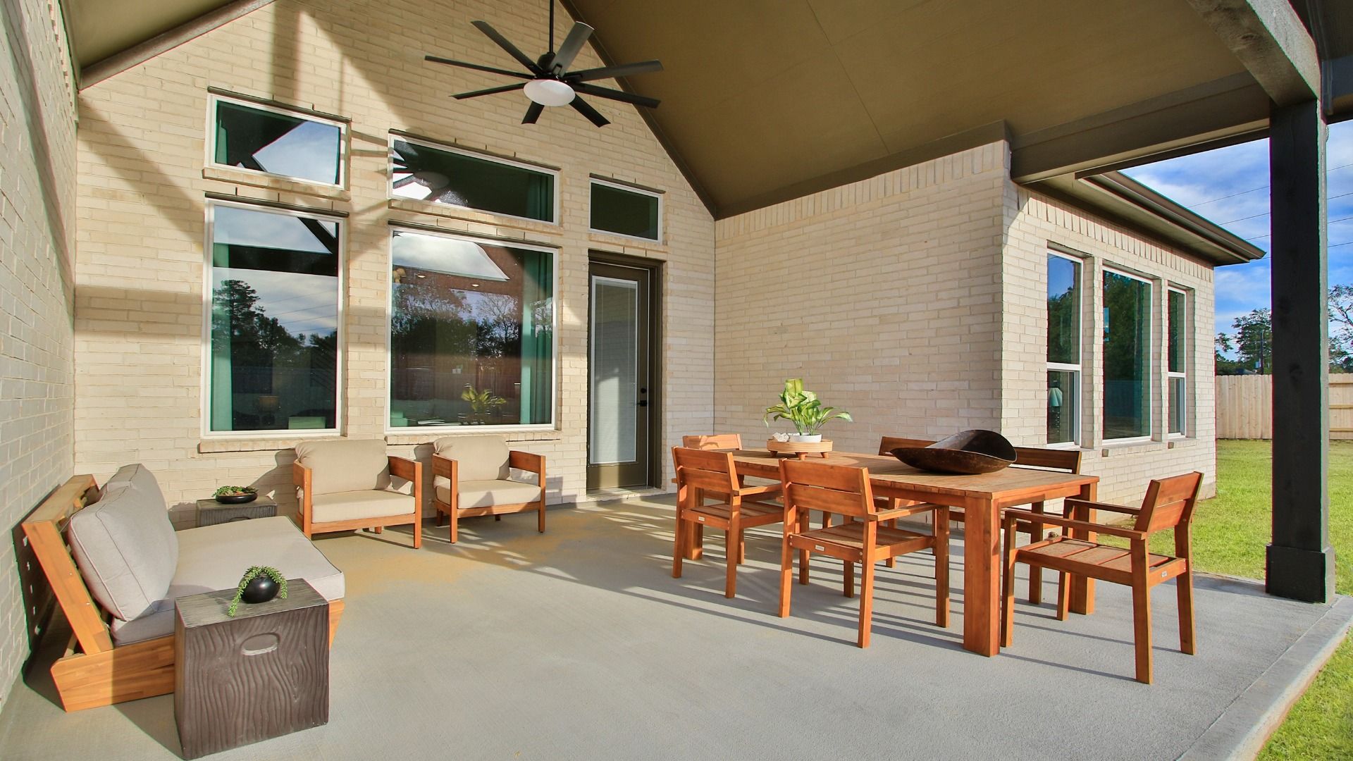 An expansive covered patio with a ceiling fan creates the perfect space for year-round relaxation in Sundance Cove.