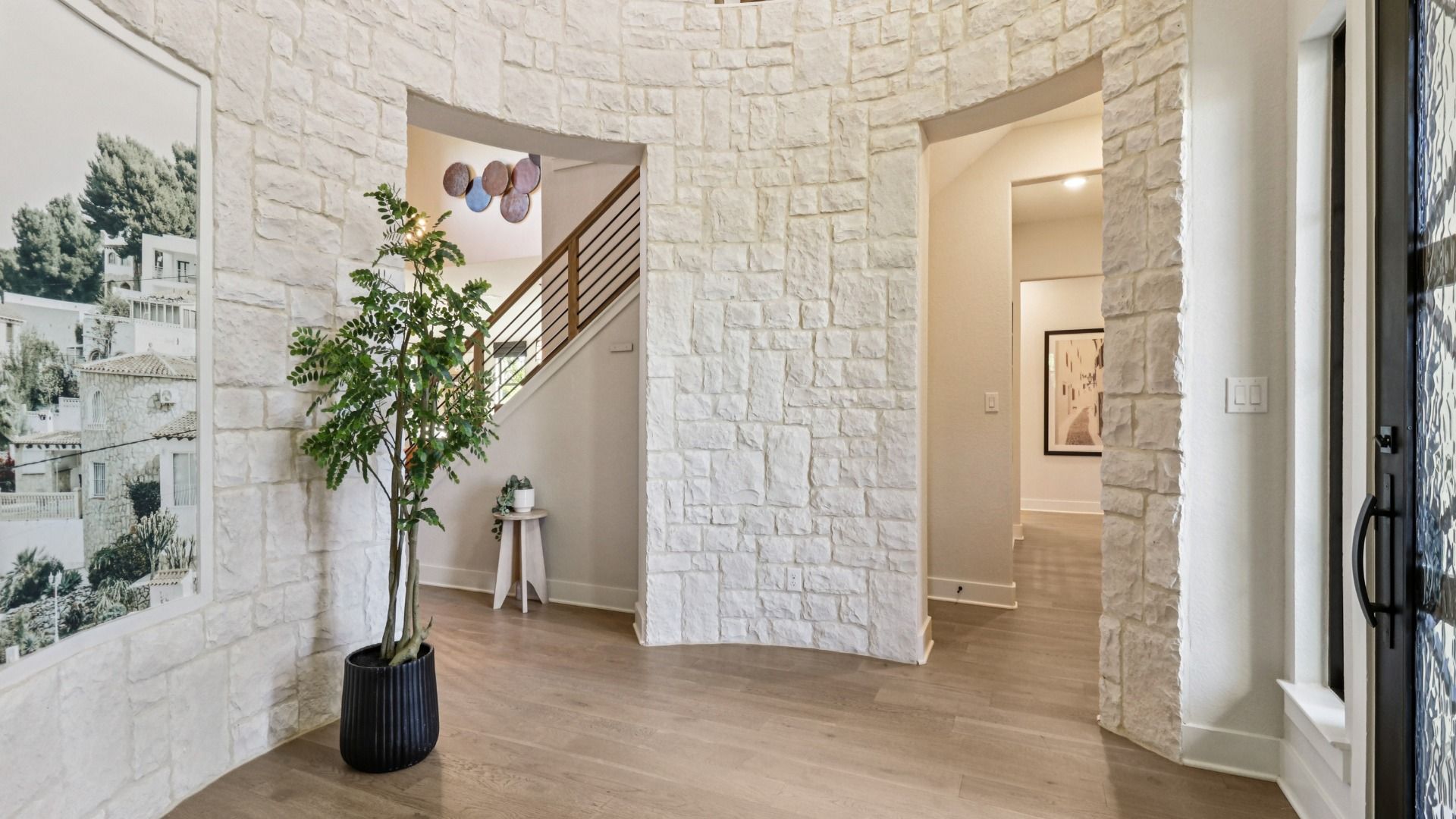 Stunning stonework and exquisite flooring elevate this Verandas at the Rim foyer to unmatched luxury.