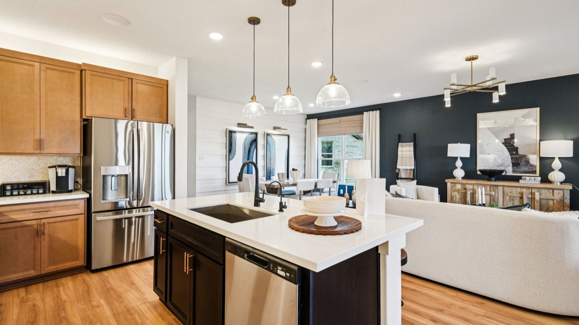 Island Features Omegastone countertops, Stainless Steel Sink, and Pendant Lighting