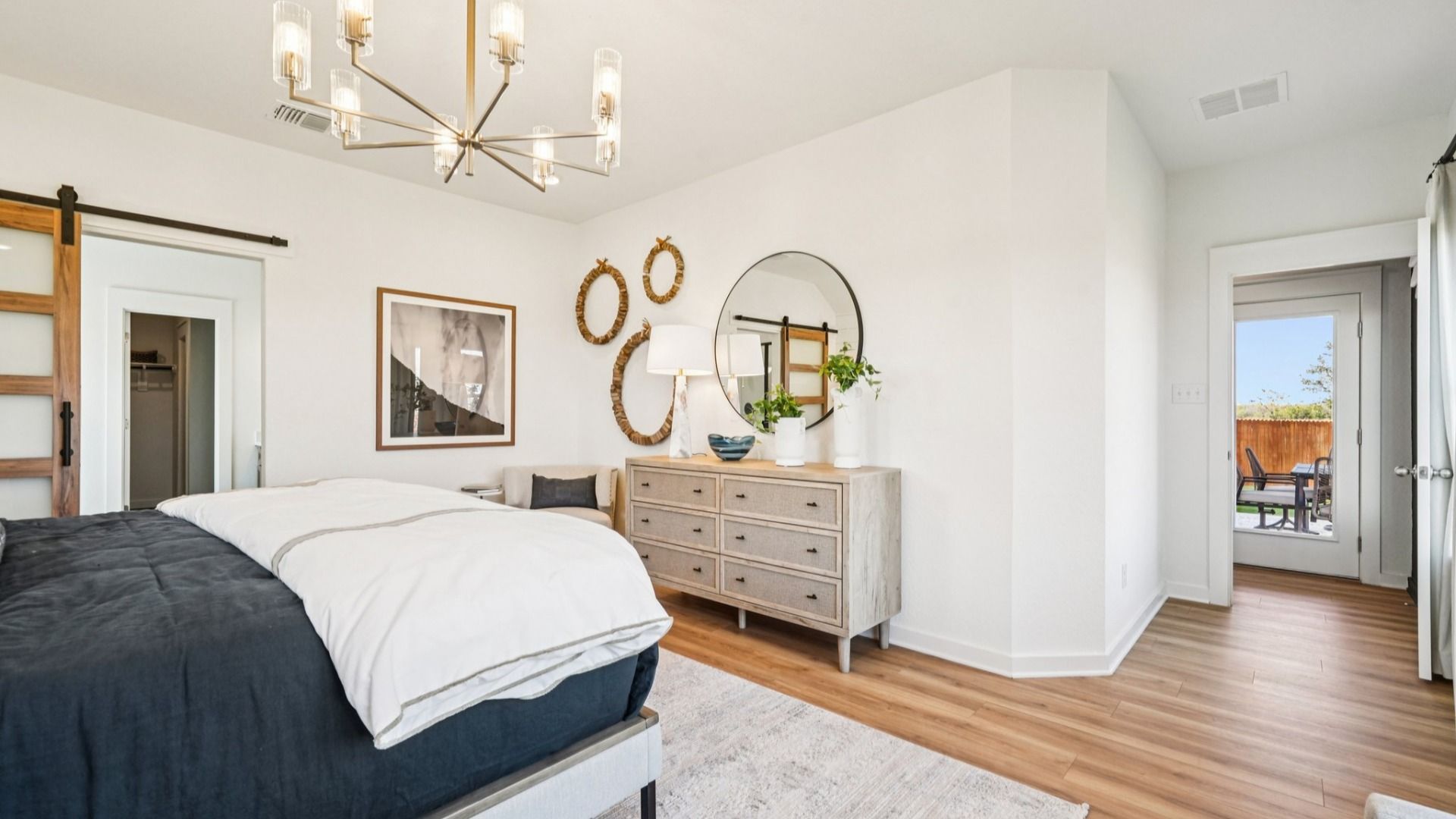 Owner's Suite is bright, with plenty of windows providing natural light, luxury vinyl floors, and woodwork on the walls