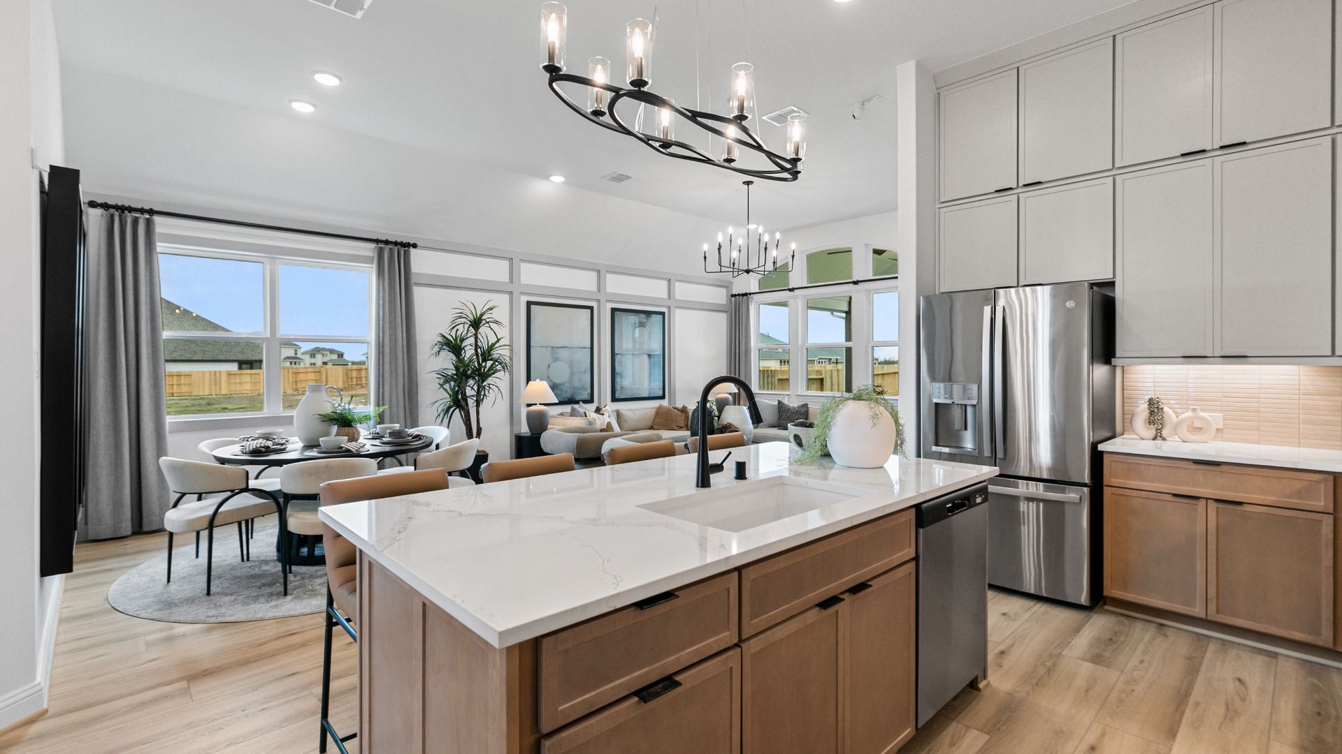 Bright open floor plan in Aldeana features kitchen, dining, and living in one connected space.