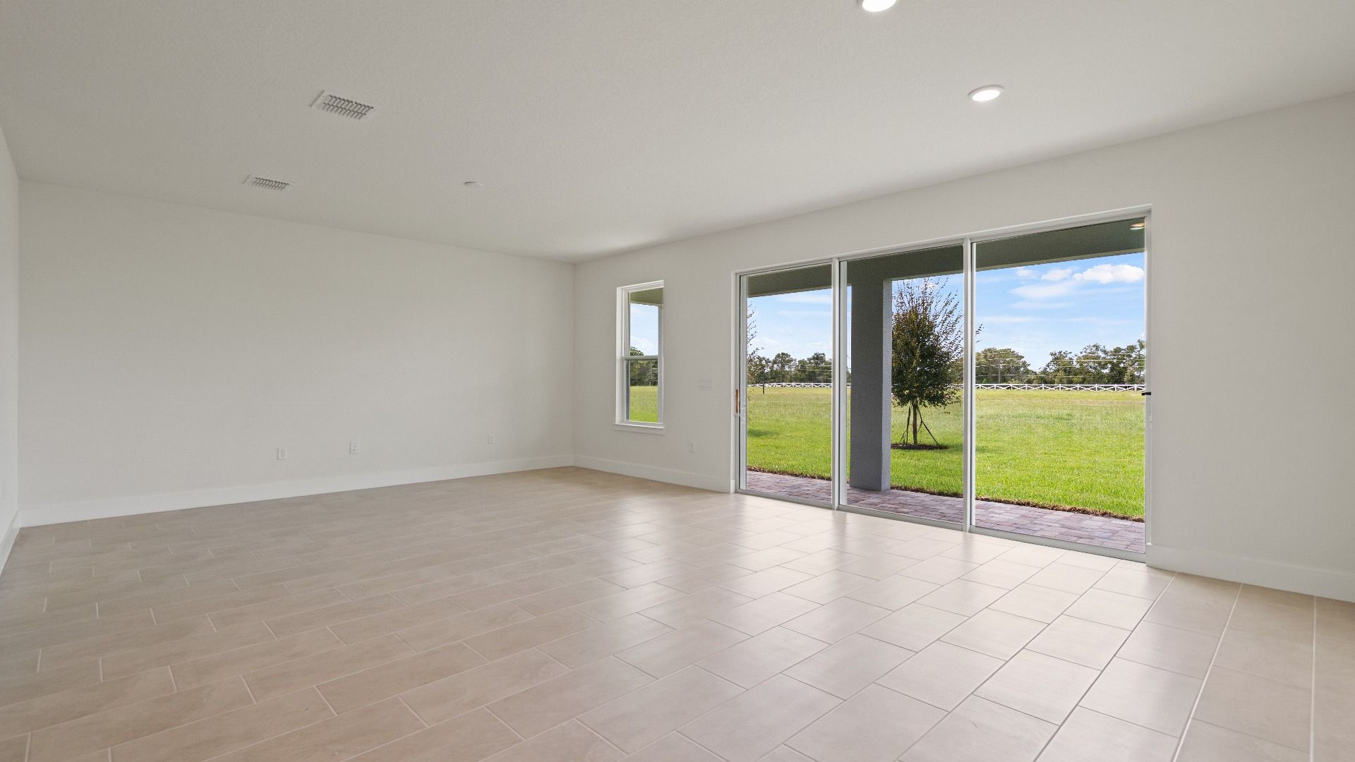 Living Area in the Buttonwood floorplan by DRB Homes at Lakeside at Satilla in Saint Cloud, FL