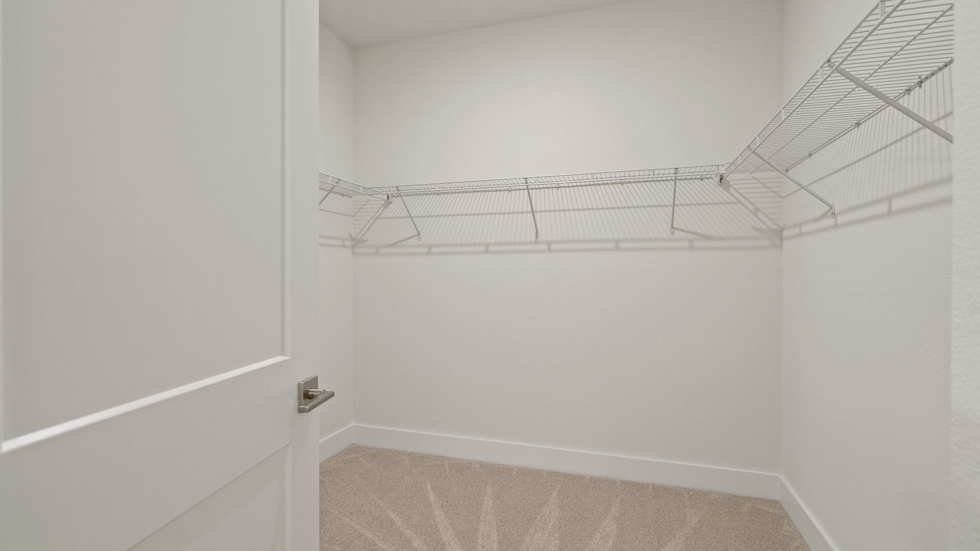 Primary walk-in closet in the Buttonwood floorplan by DRB Homes at Lakeside at Satilla in Saint Cloud, FL