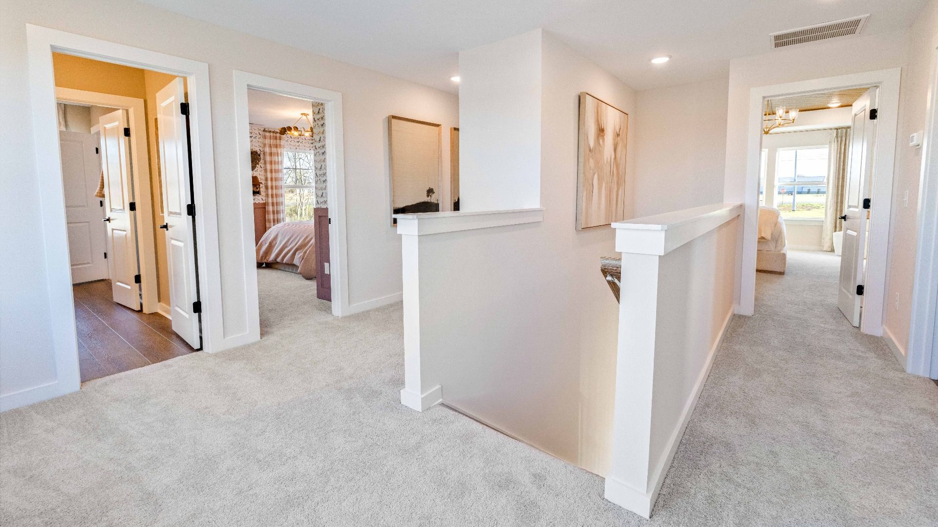 Second floor landing with view of 3 bedrooms, secondary bathroom, and hall to bonus room