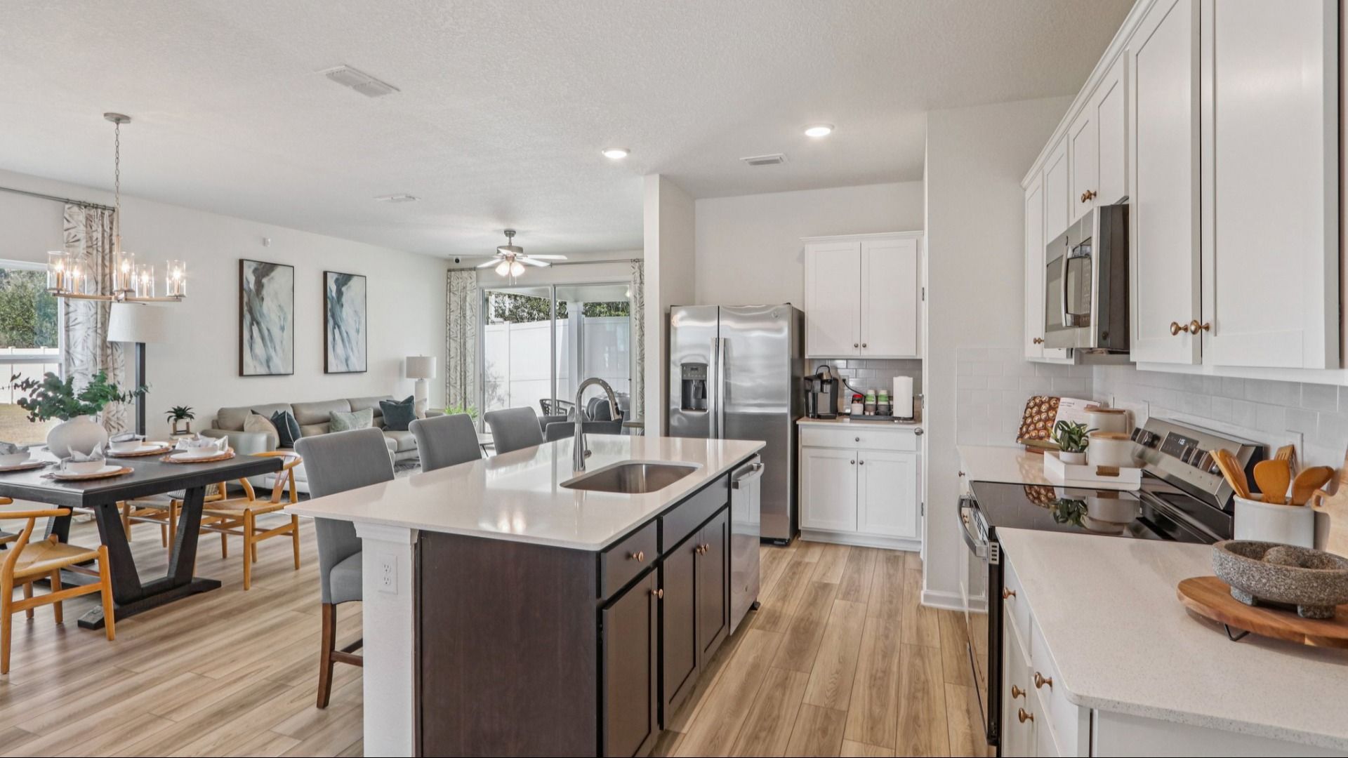 Luxurious kitchen with quartz island, stainless appliances, and designer lighting in Panther Creek.