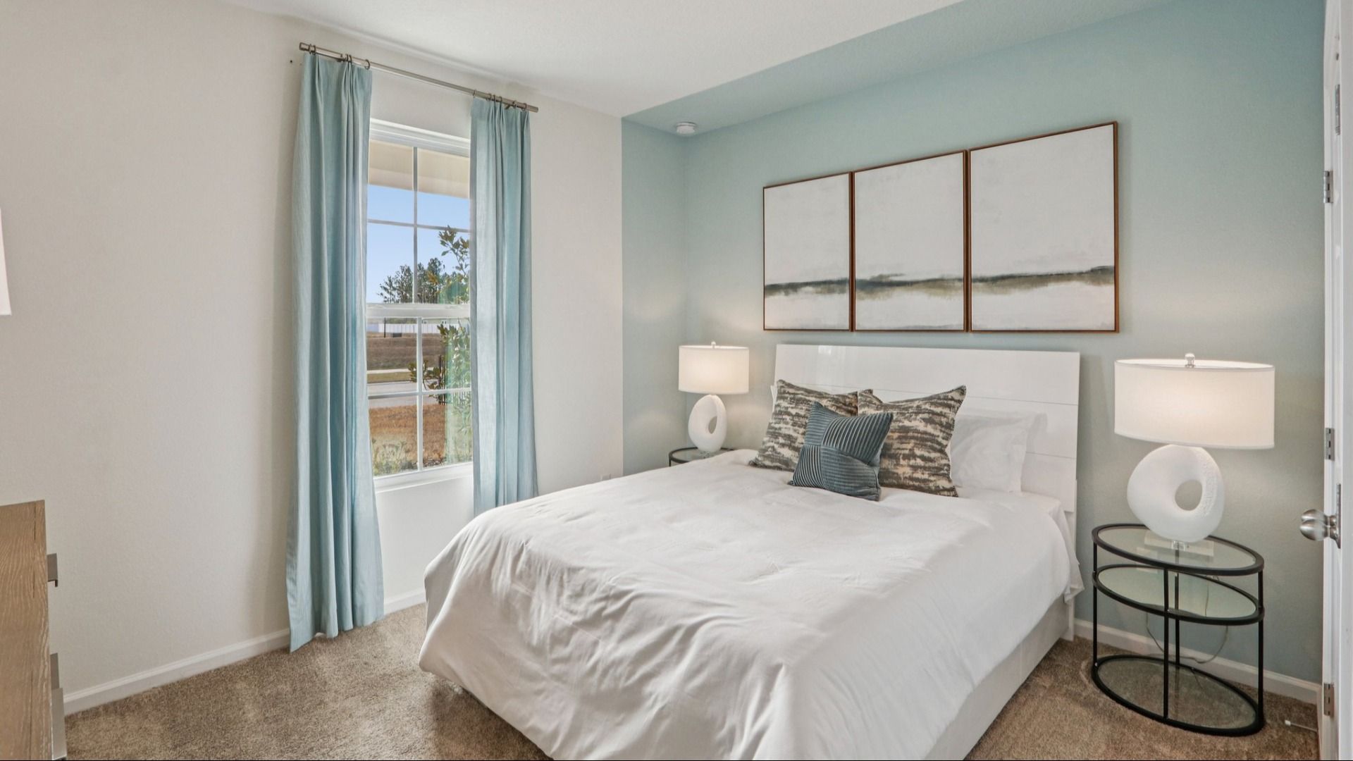 Luxurious bedroom features serene blue walls and plush carpet, offering tranquil elegance in Panther Creek.