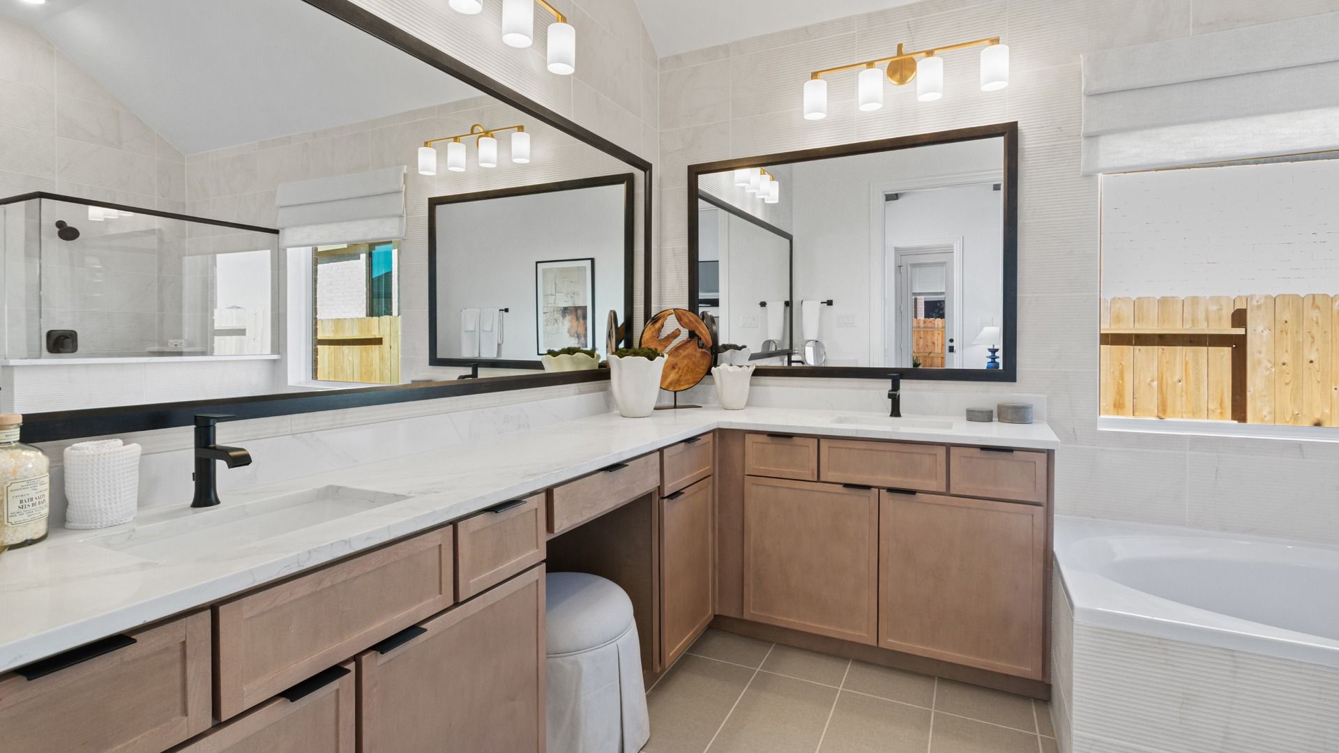 A modern primary bath featuring dual sinks, tan cabinetry, and bold accents for a stylish contrast.