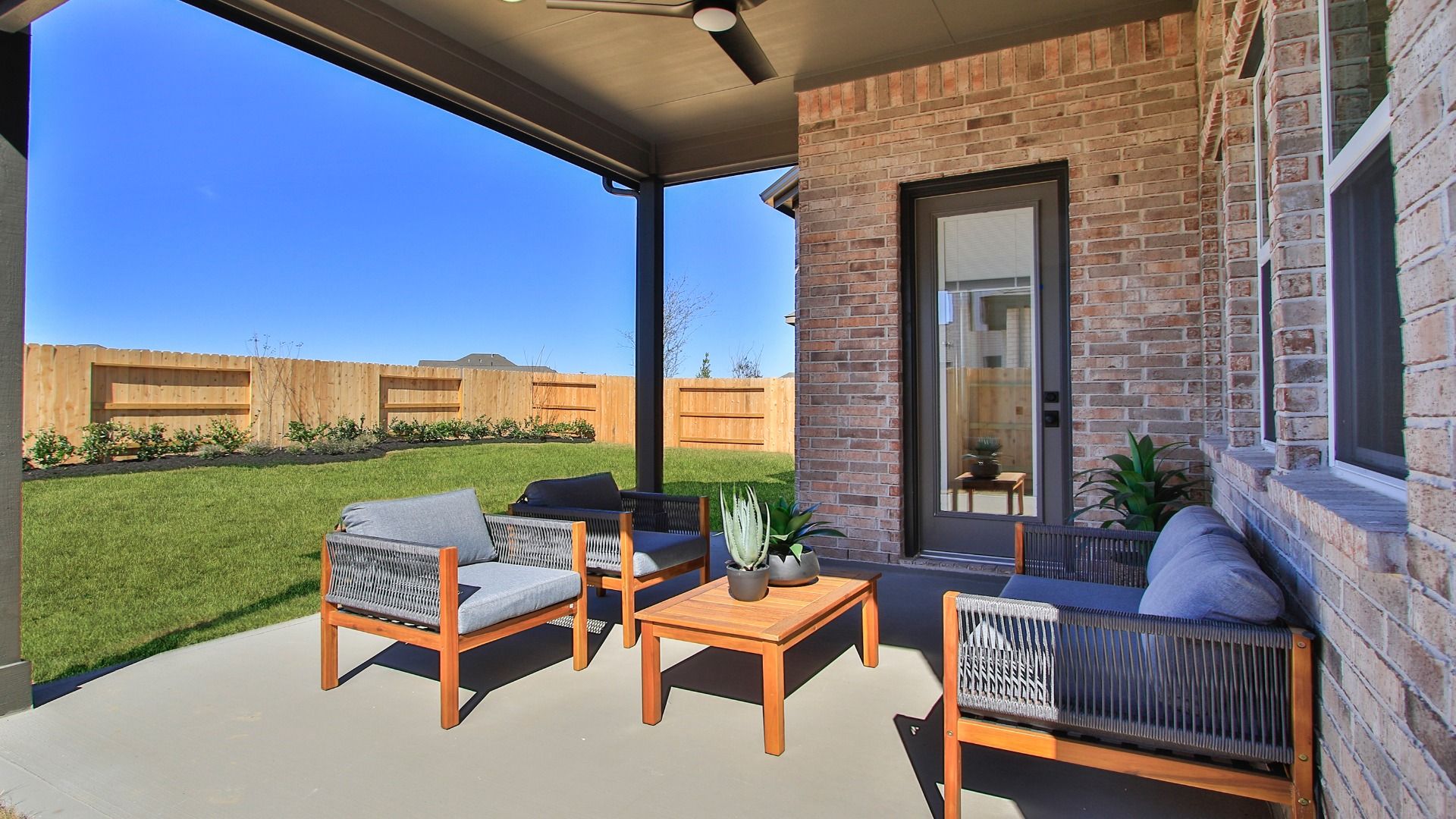 A thoughtfully designed covered patio provides the ideal space for year-round gatherings in Wildrye.