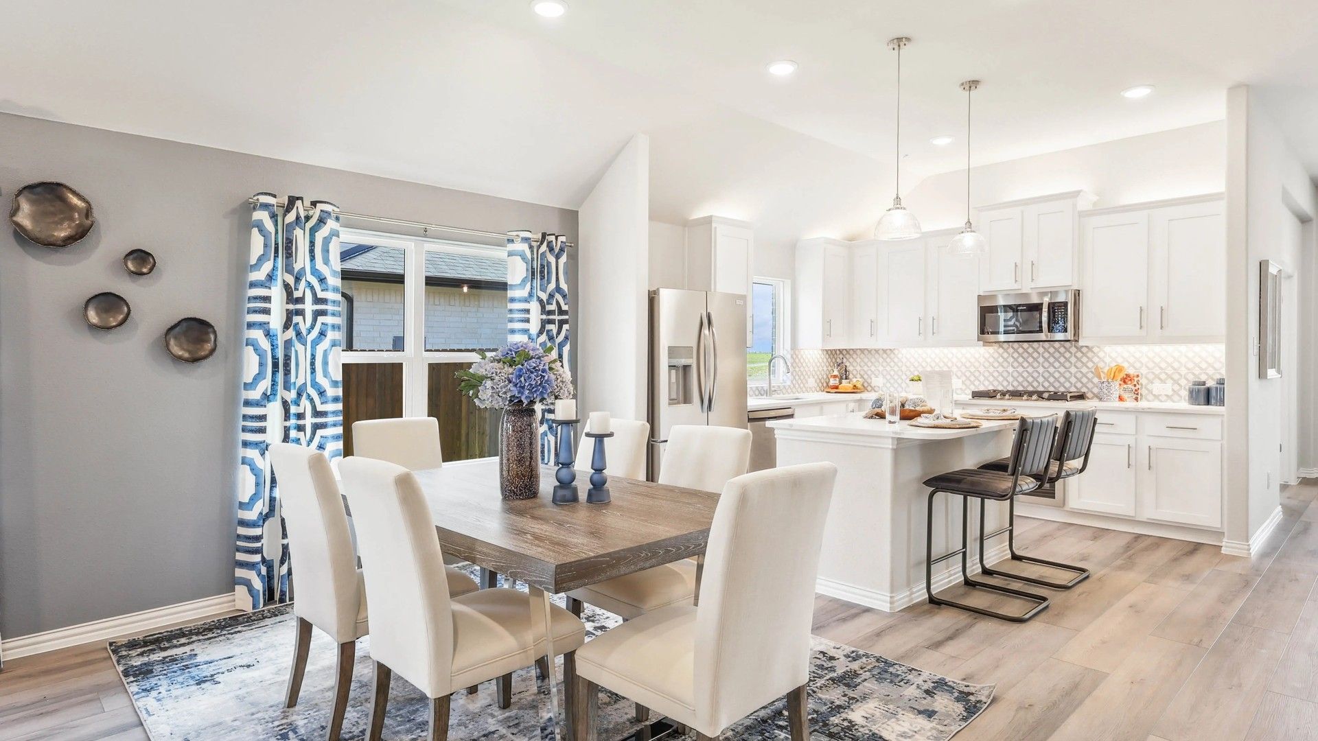 Luxurious kitchen featuring chic white cabinetry and premium wood flooring in Texas home.