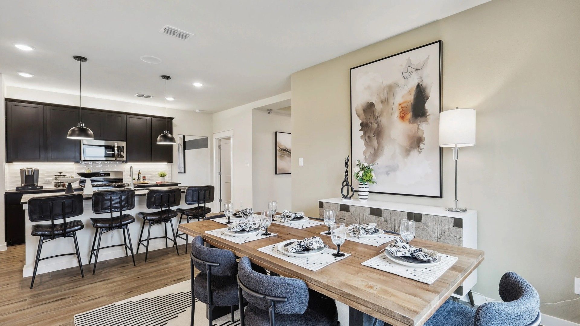 Luxurious open-plan design with sleek cabinetry, chic lighting, and exquisite furnishings at Simpson Crossing.